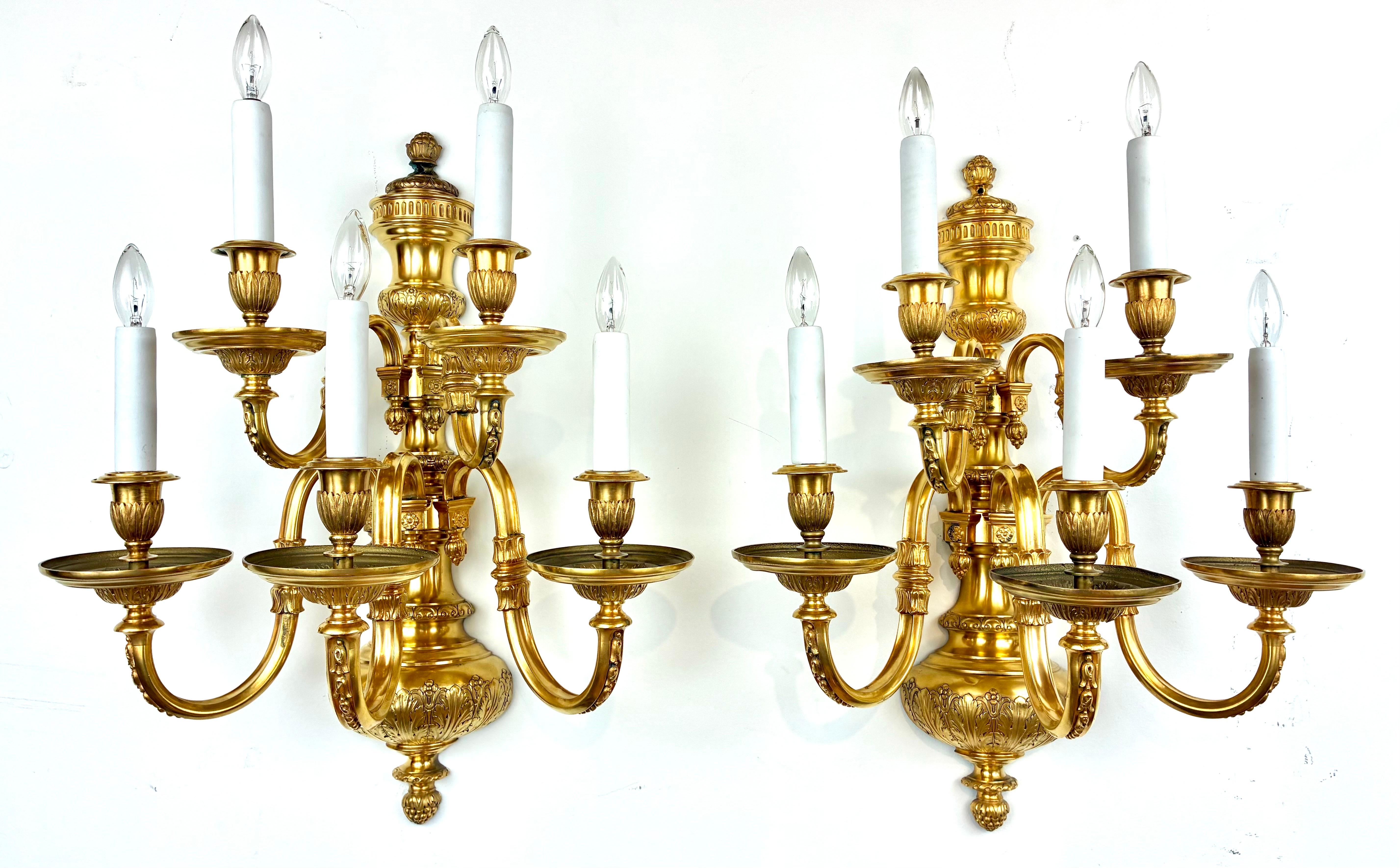 This impressive pair of early Georgian style sconces are by the renowned firm of Edward F. Caldwell. They are finely crafted in gilt bronze, and feature Classical motifs including acanthus leaves and bellflowers.