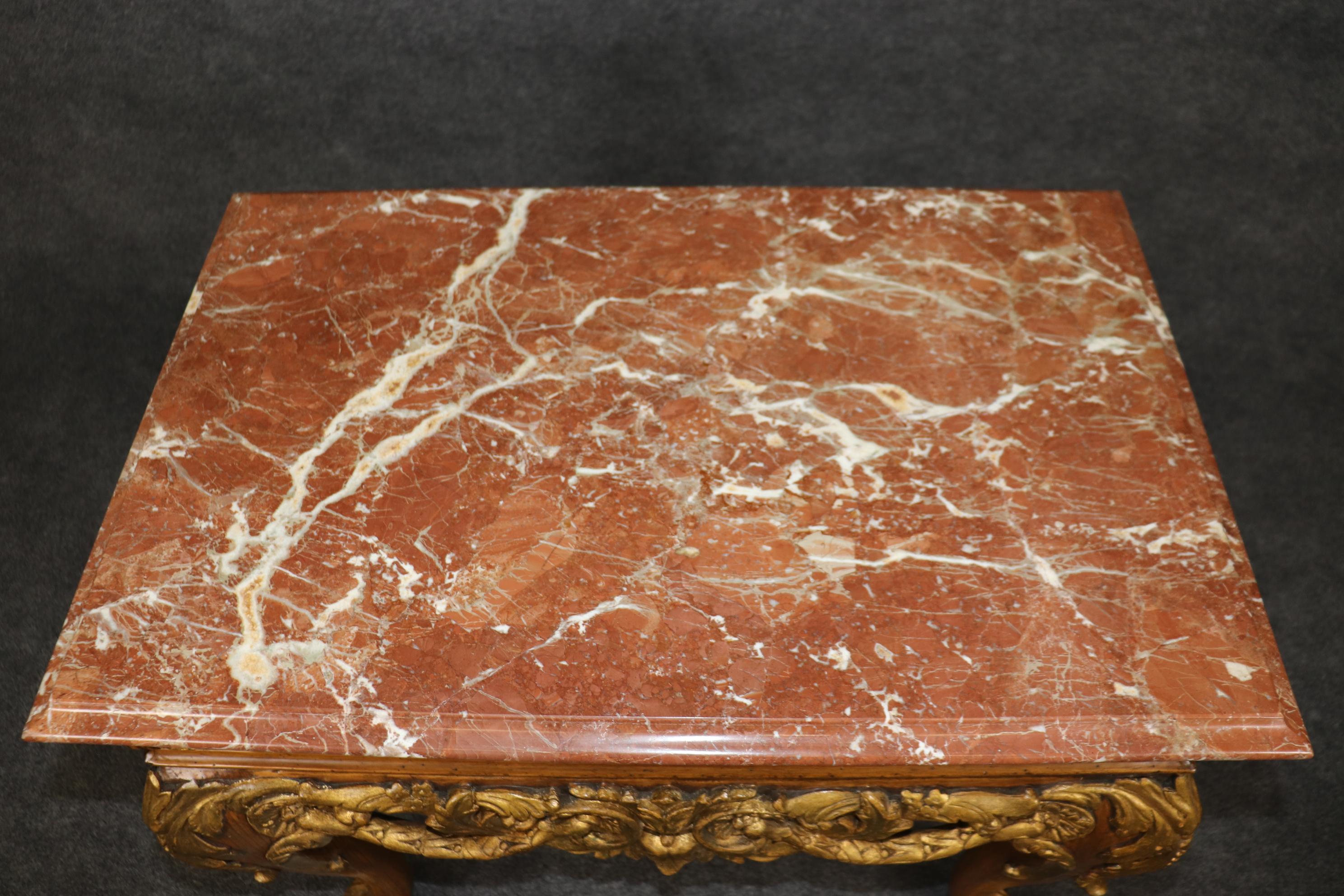 This is a gorgeous pair of Gilded and walnut Georgian style tables in the style of Maitland Smith. The tables are made in the 2000s era and in good condition with fantastic marble tops. The tables are in good condition with minor flaws and signs of
