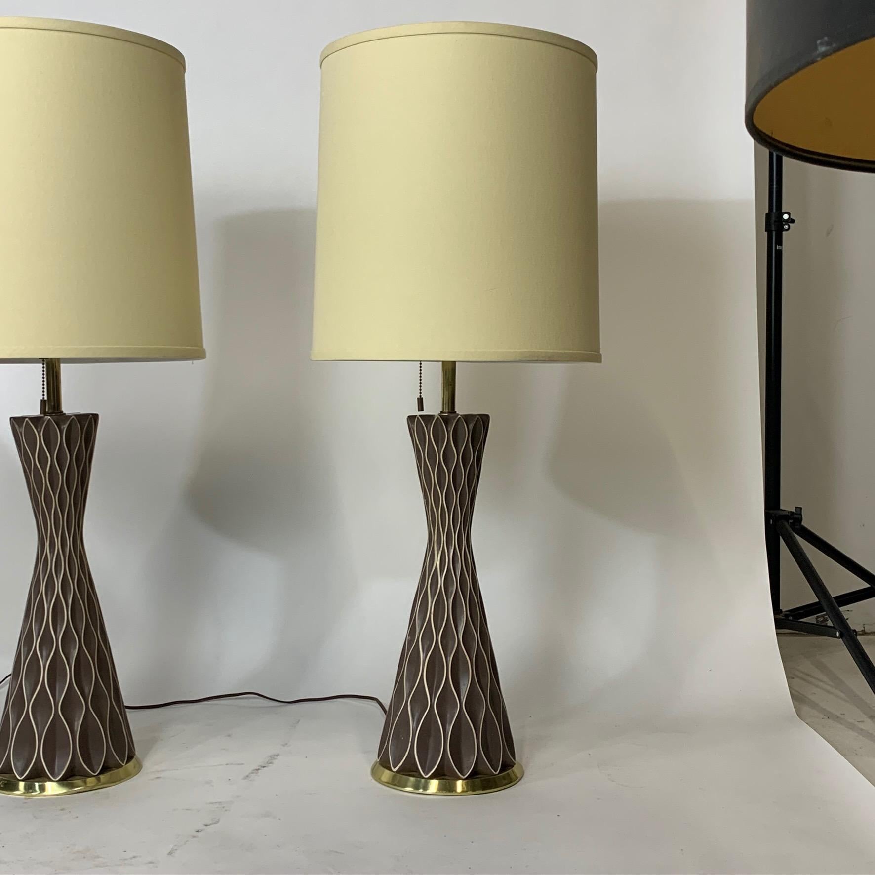 Very fine original hardware on these wonderfully delightful ceramic honeycomb lamps. Each lamp accommodates 3 bulbs. Pull switch alternates between one bulb on, two bulbs on, and three bulbs on- essentially making each lamp a 3 way light.