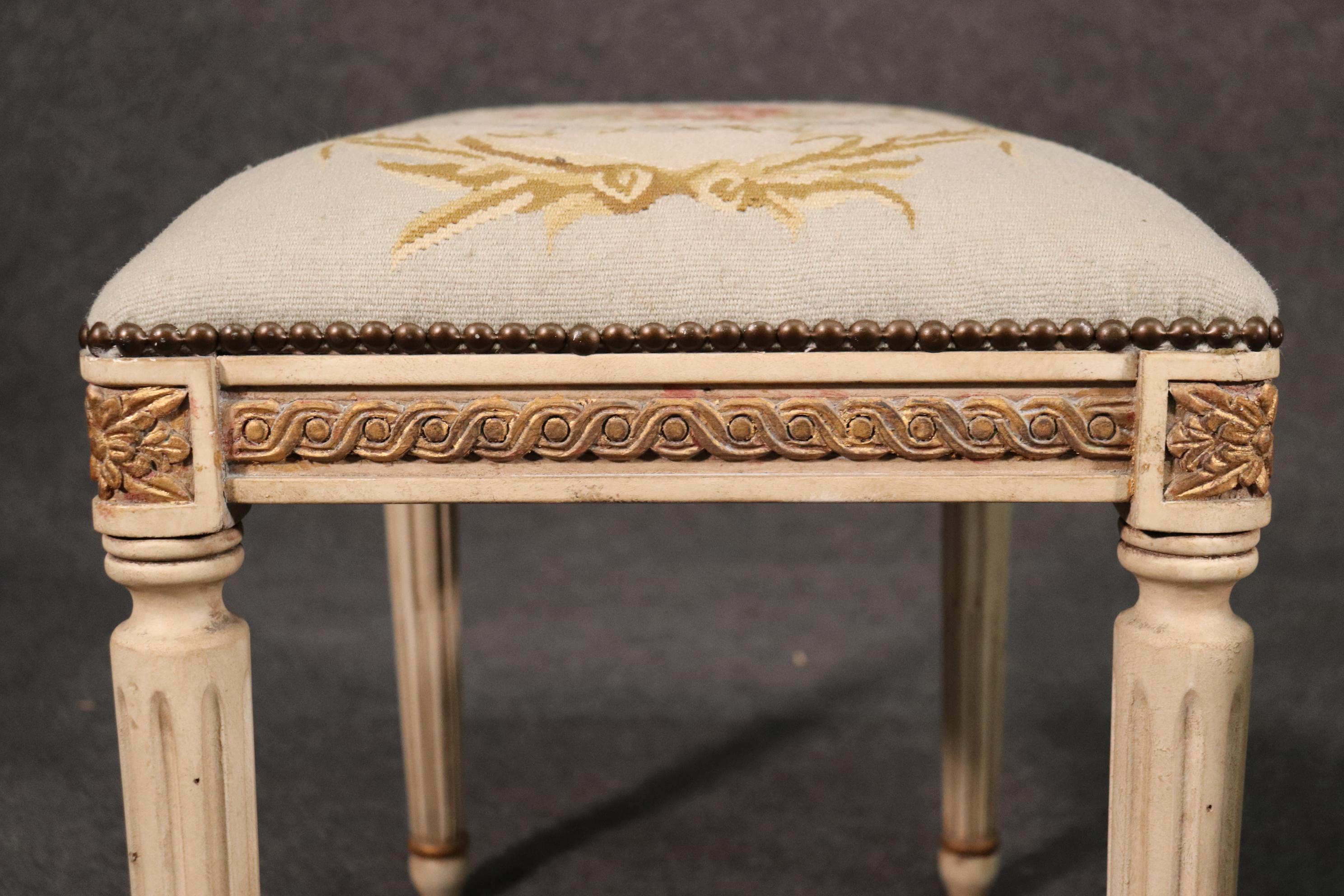 This is a gorgeous pair of stools. Look at the carved details, gold leafing and crème painted frames. The Aubusson style needlepoint looks great too. They each measure 20 tall x 23 wide x 15 deep.