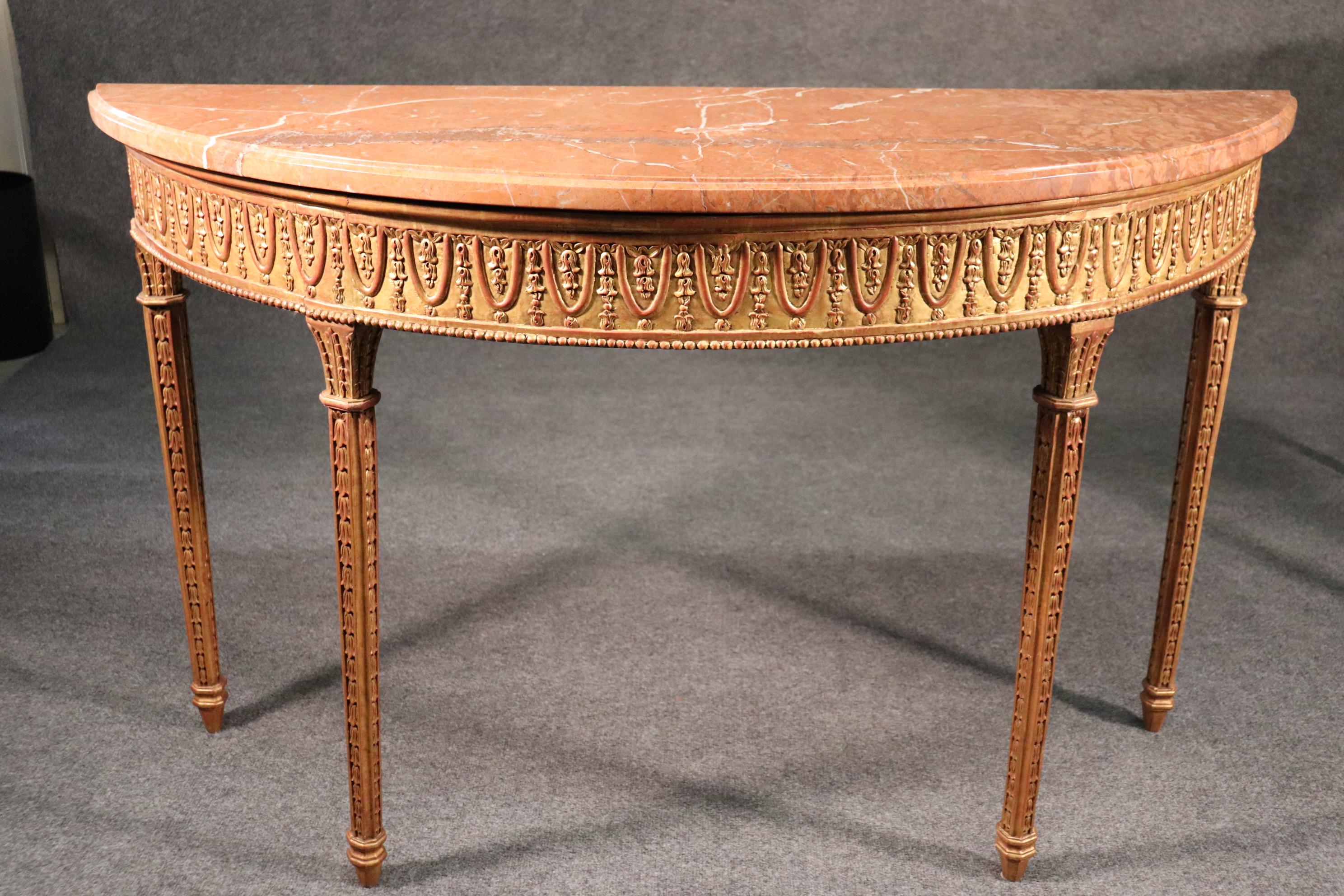 This is a fantastic pair of gilded and superbly carved marble-top console tables. The tables have wonderful marble tops and gorgeous gold leaf giltwood frames. They each measure 56 wide x 34 tall x 21 deep.