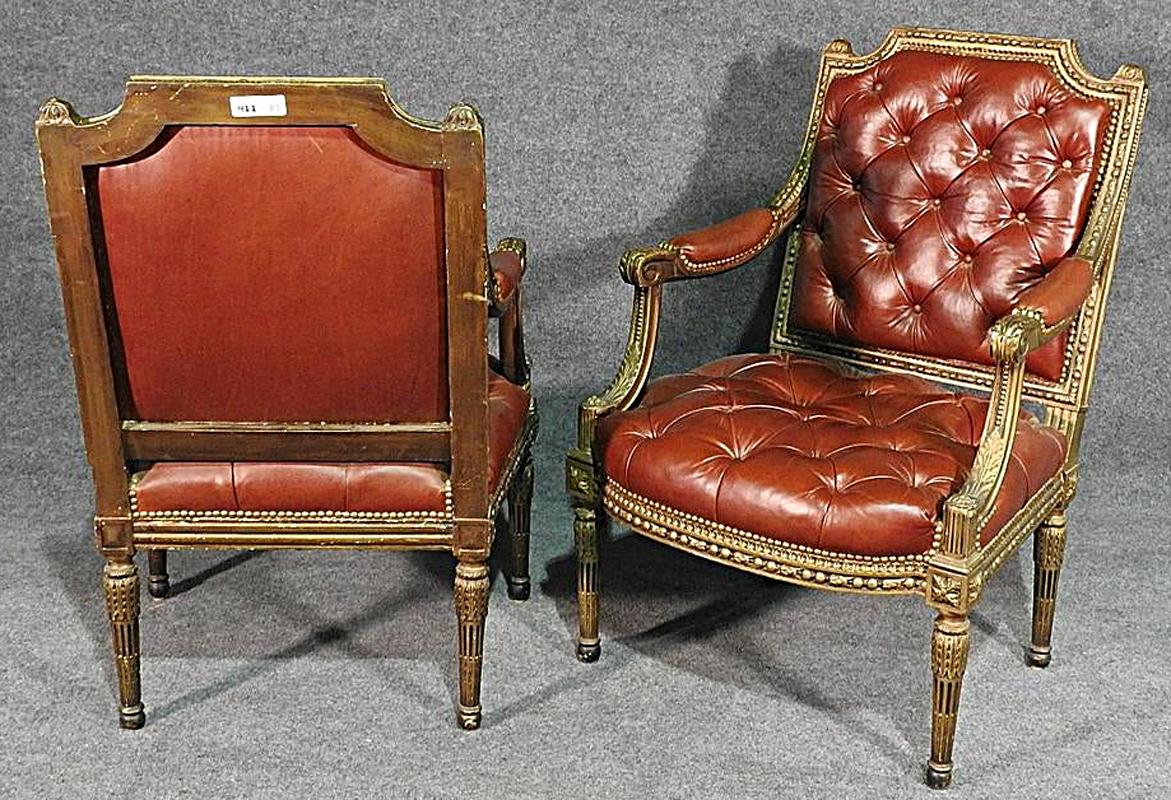 This is a gorgeous pair of carved armchairs that have every bell and whistle. The tufted leather is a beautiful tobacco brown and the frames are beautifully gilded in their original finish. The leather is in good condition and has no major issues