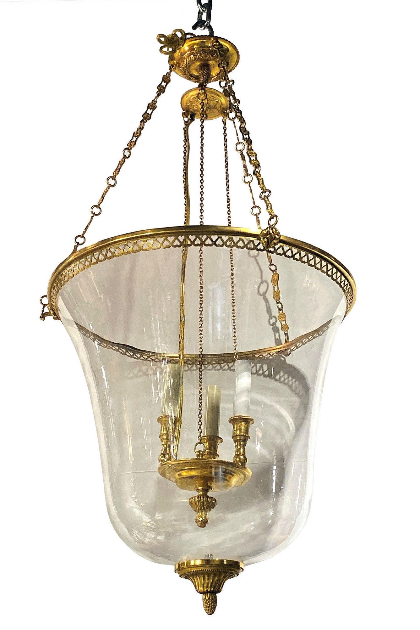 Pair of French Louis XVI style gilt bronze and glass fish bowl lanterns.