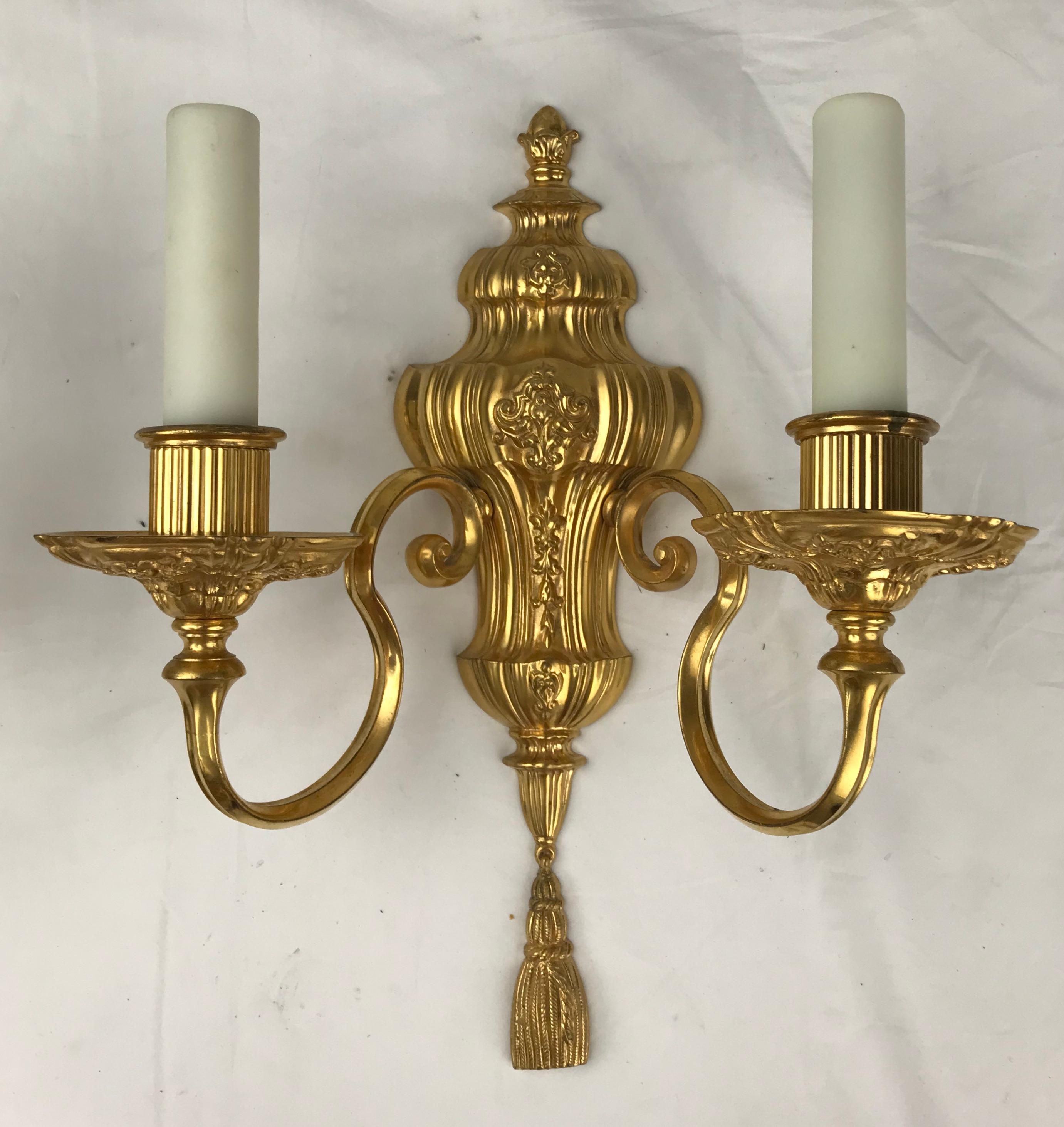 This handsome pair of gilt bronze sconces are attributed to the renown firm of E. F. Caldwell. The original gilding is in excellent condition, The sconces have been newly rewired, and are ready to install.