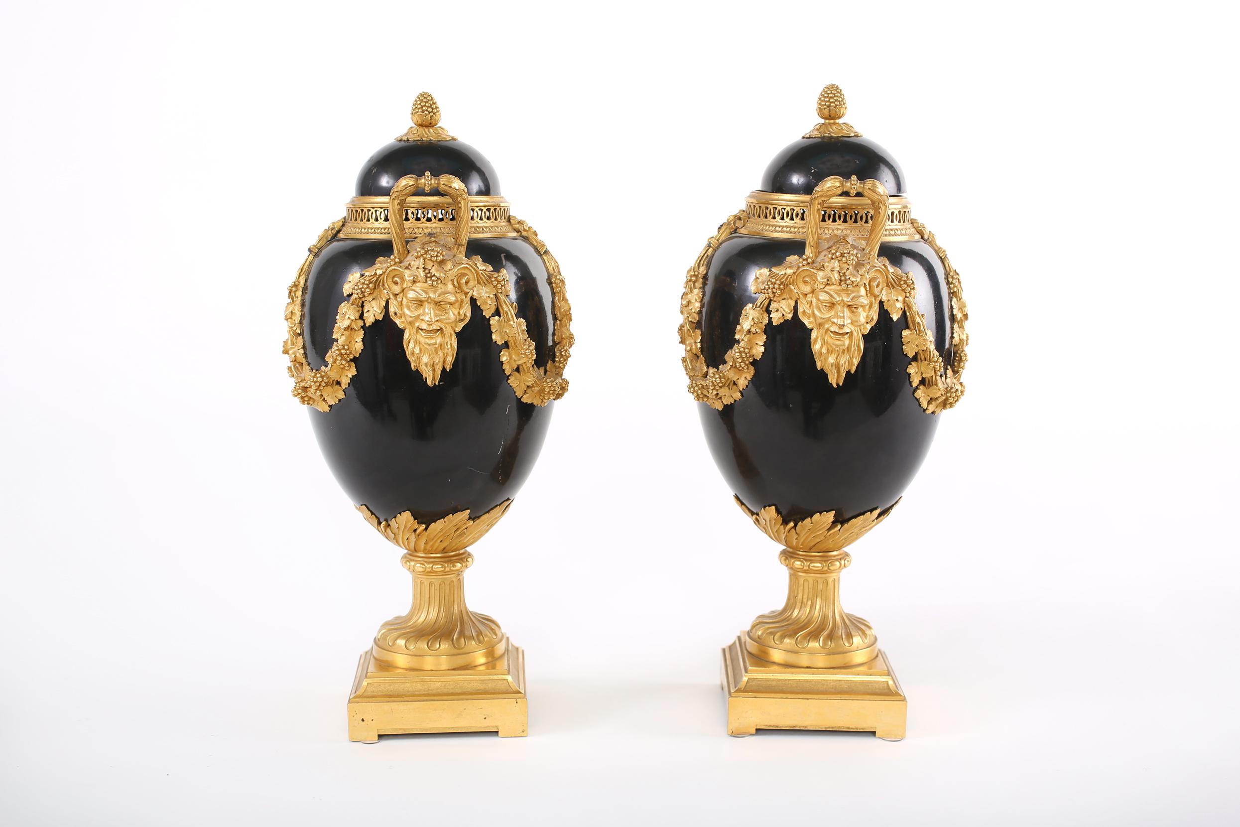 Pair continental gilt bronze mounted covered urns with side handles & exterior design details. Each urn is in good vintage condition. Minor wear consistent with age / use. Each one stands about 12-1/2 inches x 6-1/2 inches x 5- 1/4 inches.
 