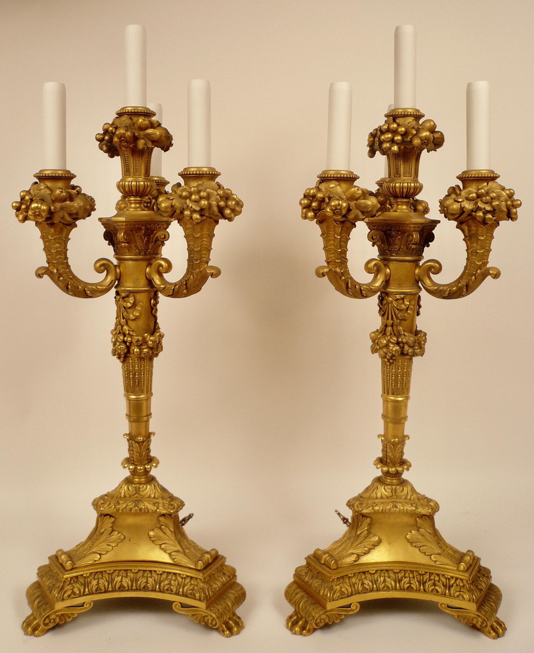 This impressive pair of Louis XVI style gilt bronze candelabra are signed by the famous maker E.F. Caldwell. they retain their original gilt finish and porcelain candles!