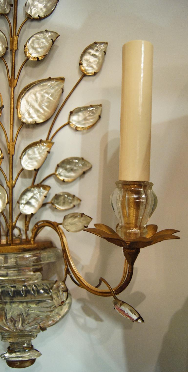 Pair of circa 1920’s French gilt metal double-arm sconces with original patina.

Measurements:
Height: 18.5