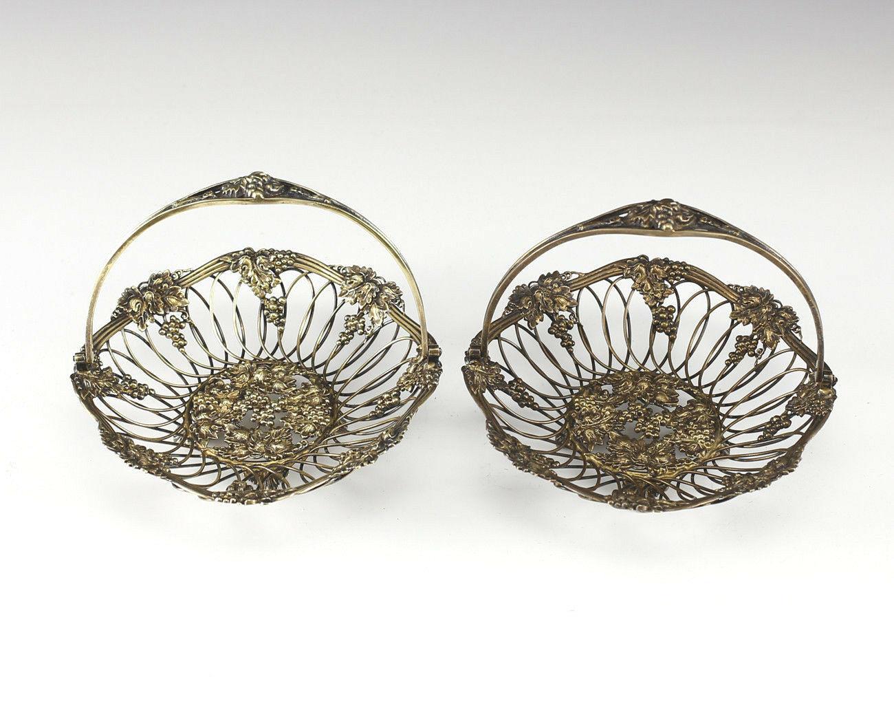 Pair of Gilt Sterling Silver Reticulated Swing Handle Footed Baskets by Howard & Co. Grape and leaf motif. C1920

Additional information:
Composition: Sterling Silver 
Maker: Howard & Co.
Type: Baskets 
Age: 1900-1940
Dimension: 6