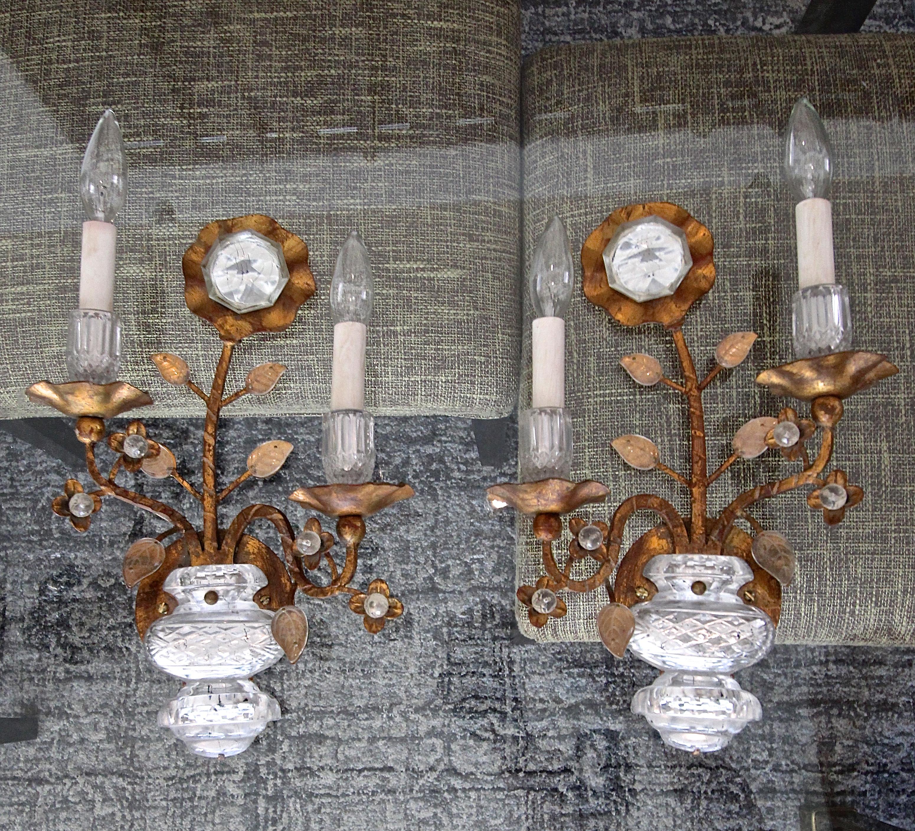 Pair of gold gilt metal wall sconces accented with flower and urn motif, manufactured by Banci Firenze for Sherle Wagner. Each sconce uses two candelabra size bulbs. Rewired. Retains original brass 