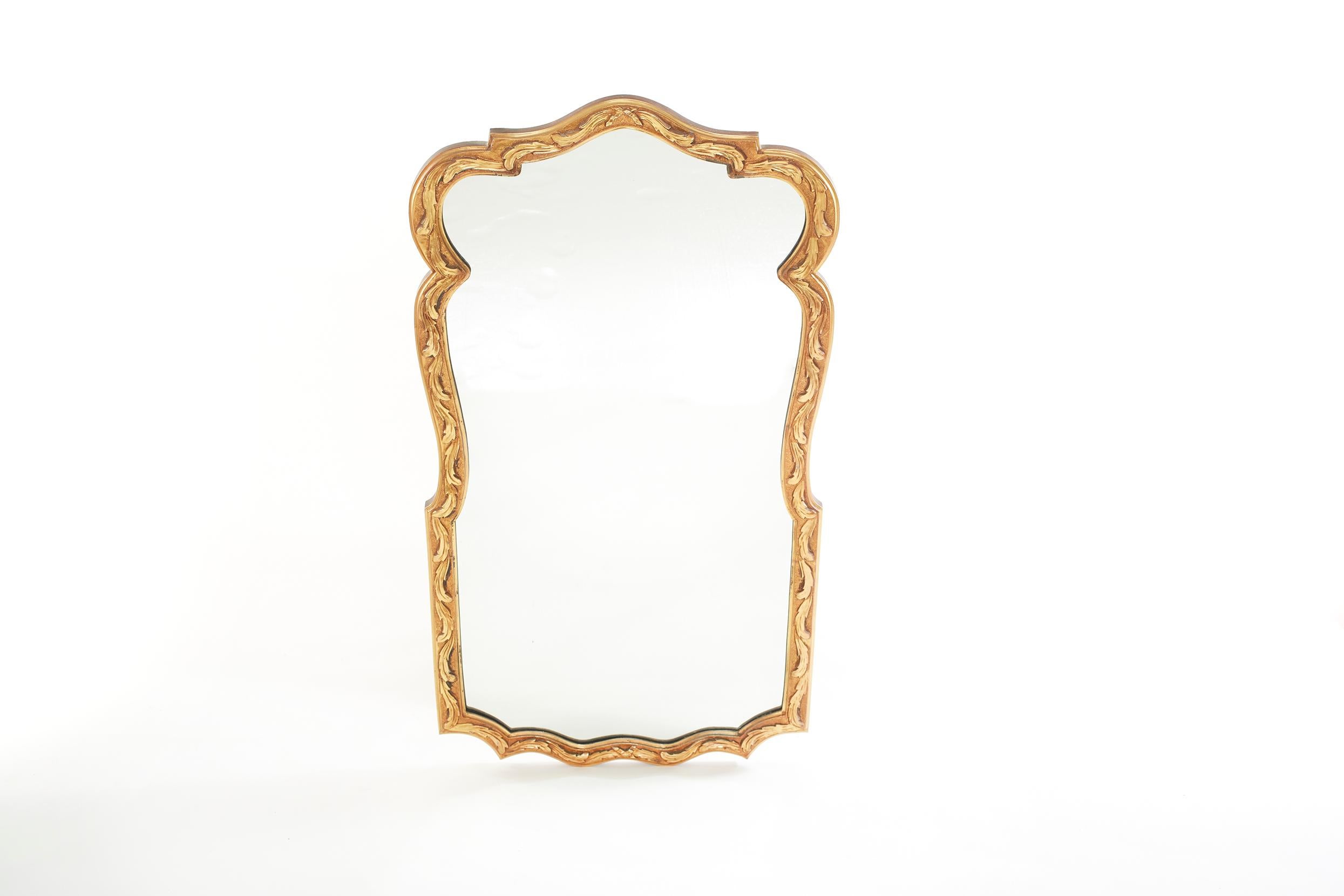 Beautiful pair of gilt wood framed beveled hanging wall mirror in a geometric shape with hand carved design details motif. The mirror is in good condition. Minor wear consistent with age / use. The gilt wood frame measure 48 inches high X 26 inches