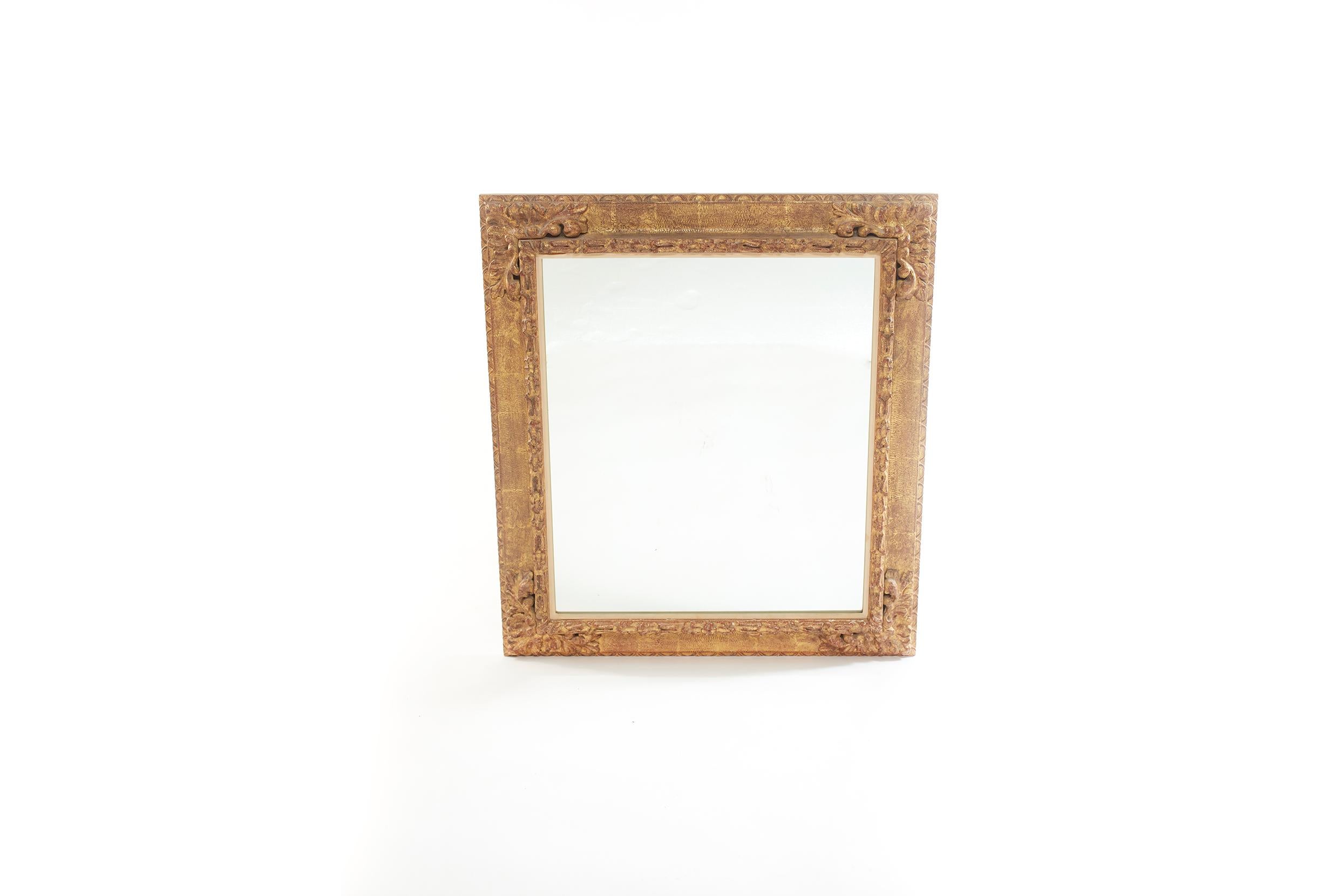 Pair of gilt wood framed beveled hanging wall mirror in an square shape with hand carved design details motif. The mirror is in good condition. Minor wear consistent with age / use. The gilt wood frames measure 38.5 inches high x 33.5 inches wide.