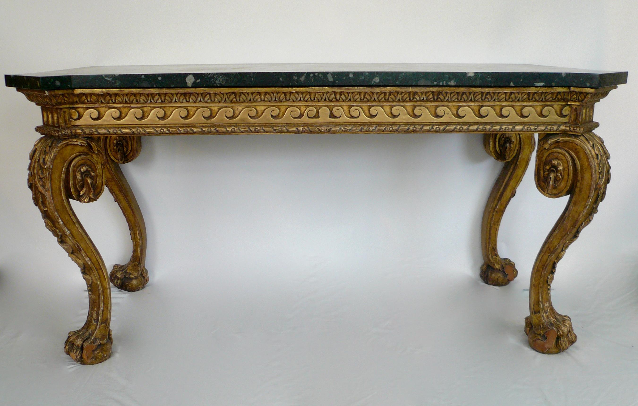 This truly fantastic pair of carved and giltwood pier, or console tables are of William Kent design. They feature acanthus leaf carved knees, Vitruvian scrolled apron, and hairy paw feet, on dark green marble tops.



  