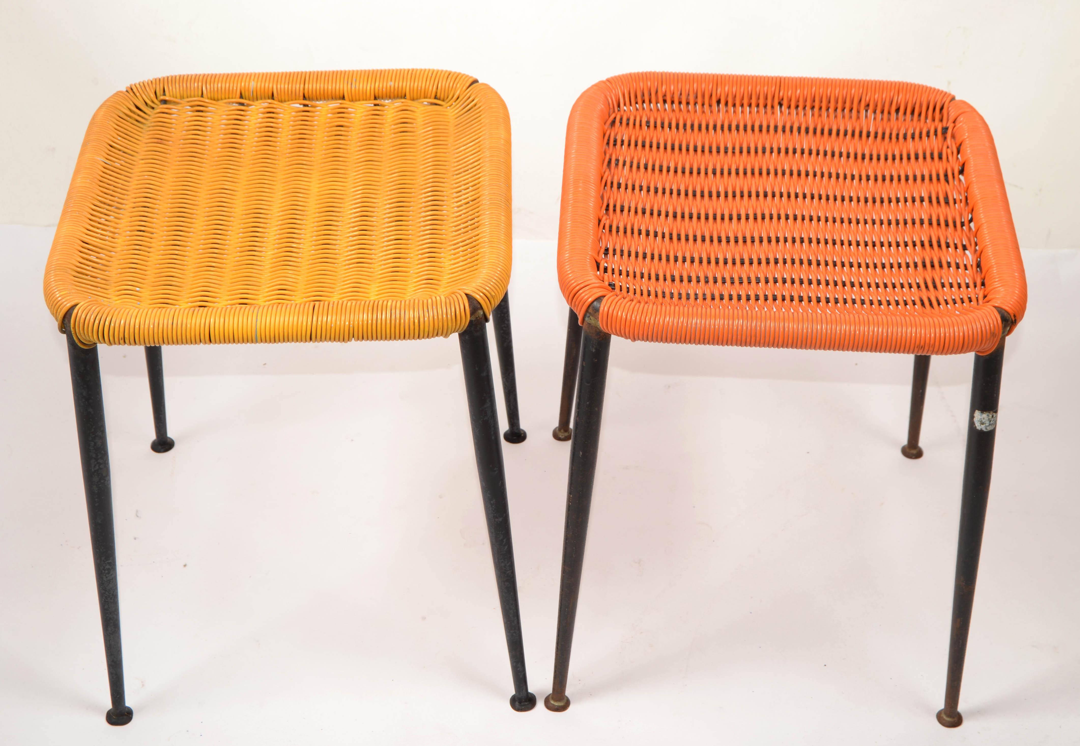 1960s Gio Ponti Style Mid-Century Modern Stools in original orange & Yellow handwoven plastic seat.
Minimalist Tubular Steel Core in distressed black finish with sturdy seats.
Accent Stools made in Italy, a design classic. 
Faded Foil Label at the