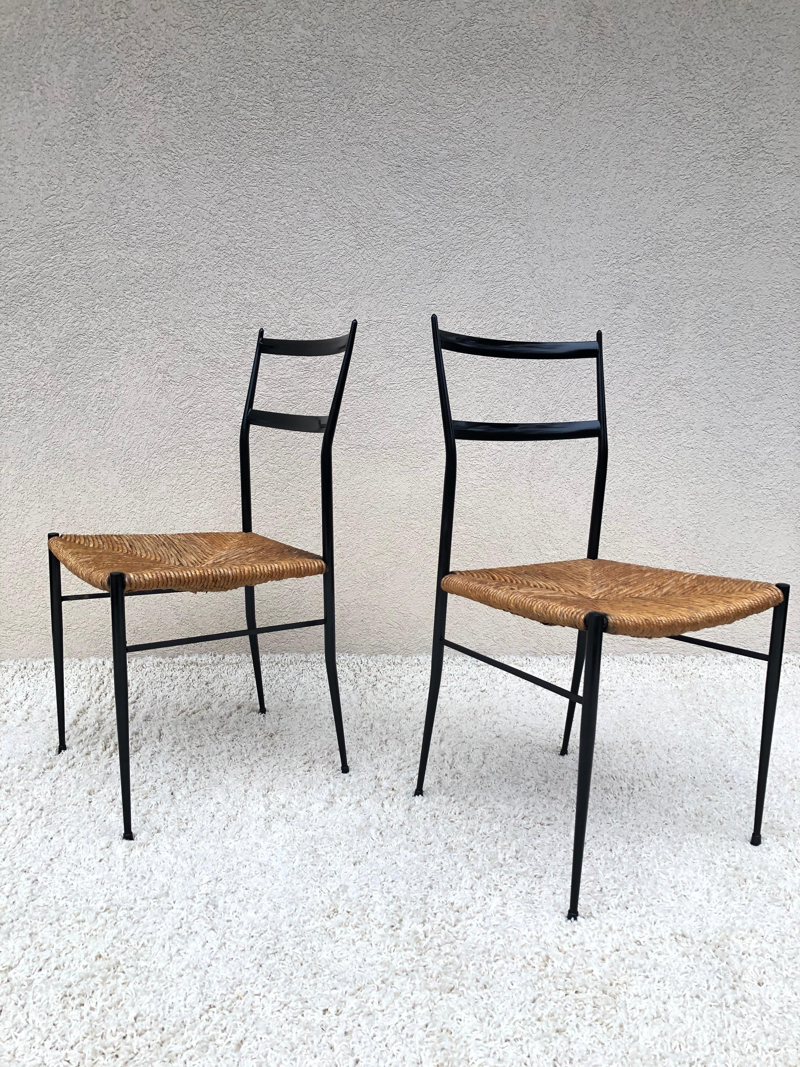 Pair of Superlegga inspired chairs, in the style of Gio Ponti, circa 1960. The original design was made for a project in Eindhoven, where Gio Ponti designed the outside of the building, chairs are metal with authentic original woven straw seats.
