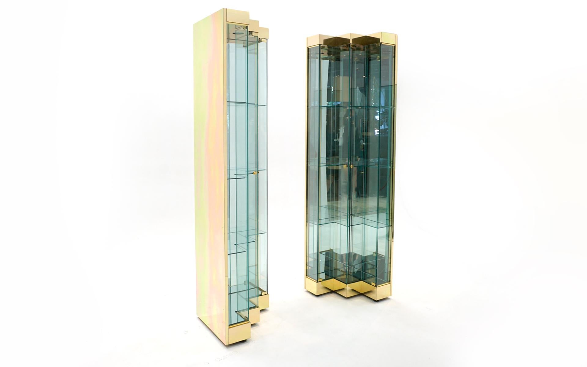 Pair of tall and narrow display / storage cabinets in brass and glass.  Possibly by Ello.  Super high quality construction.  Unique 