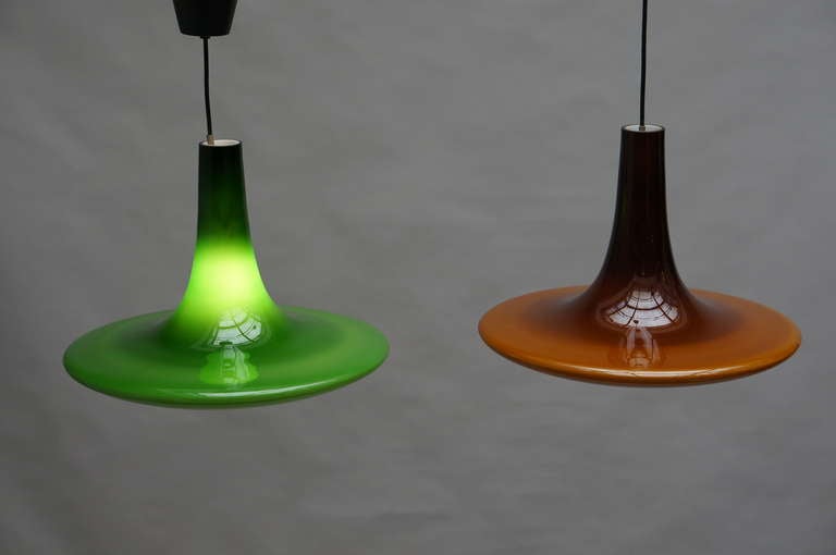 Two superb pendant lights in green and brown by the company of Peil and Putzler from Germany. The glass consists out of two layers. A white inner layer and a brown and green outside. The glass is from the island of Murano in Italy. When lit, the