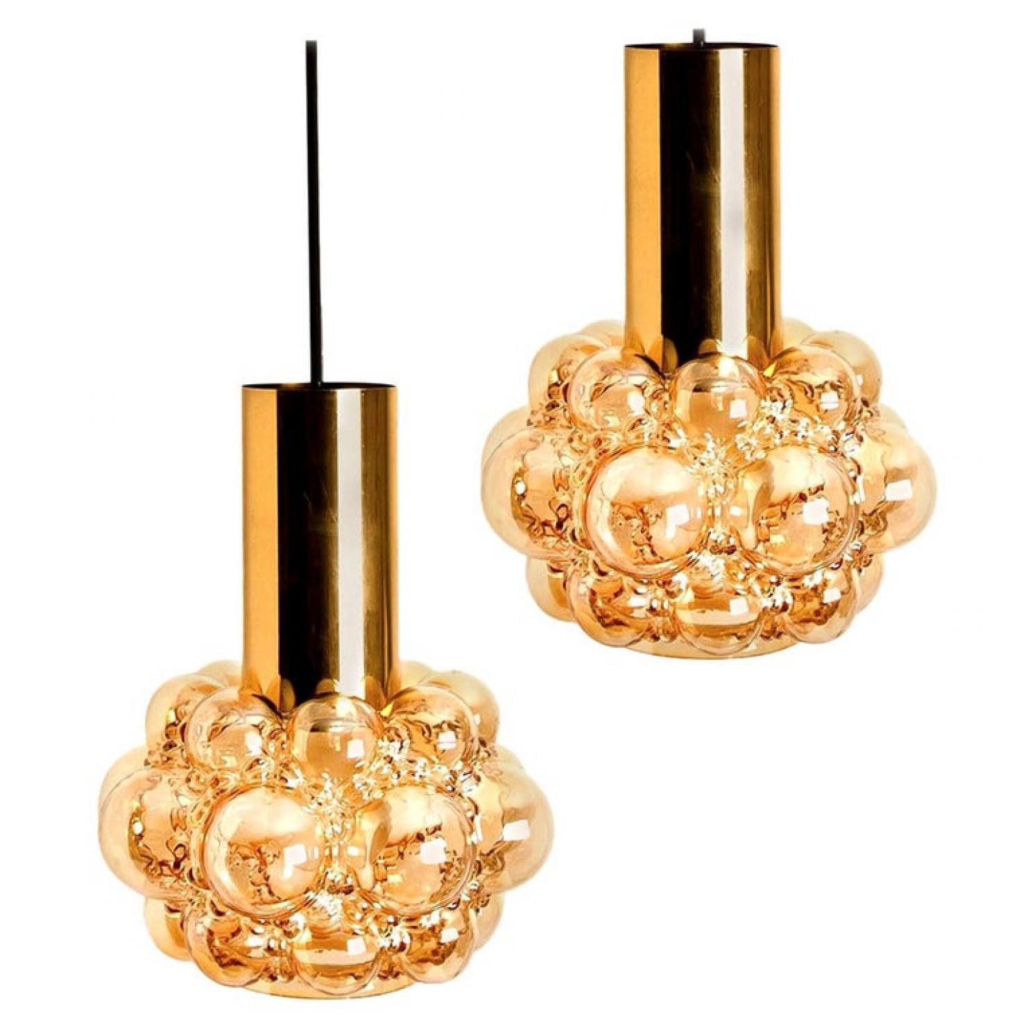 Pair beautiful bubble glass chandeliers or pendant lights designed by Helena Tynell for Glashütte Limburg. A design Classic, the amber colored/toned hand blown glass gives a wonderful warm glow.

Measures: Diameter 9.8 in (25 cm), height body