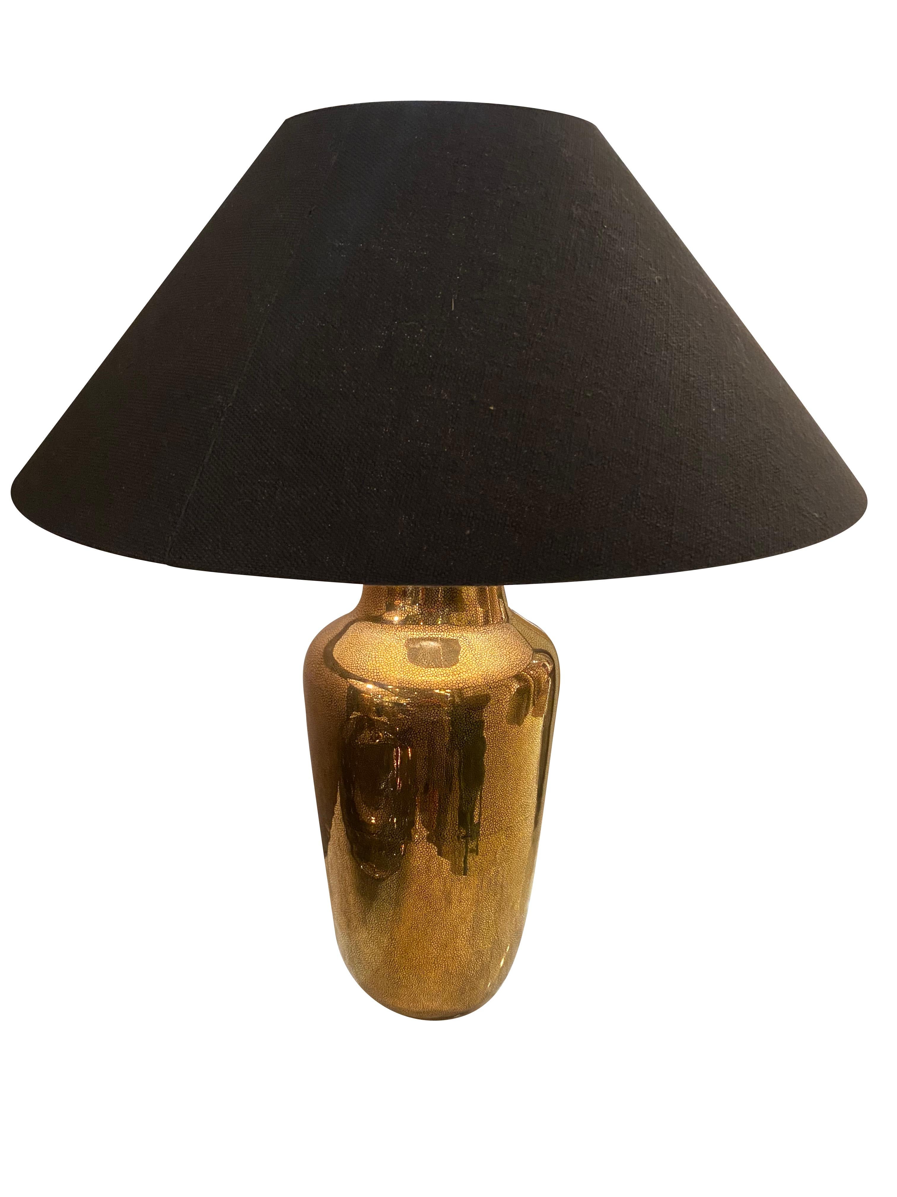 Contemporary Chinese pair of gold faux shagreen lamps. The faux shagreen design is affixed to a porcelain base.
The lamp is designed in a ginger jar shape.
Belgian black linen shade with gold interior.
