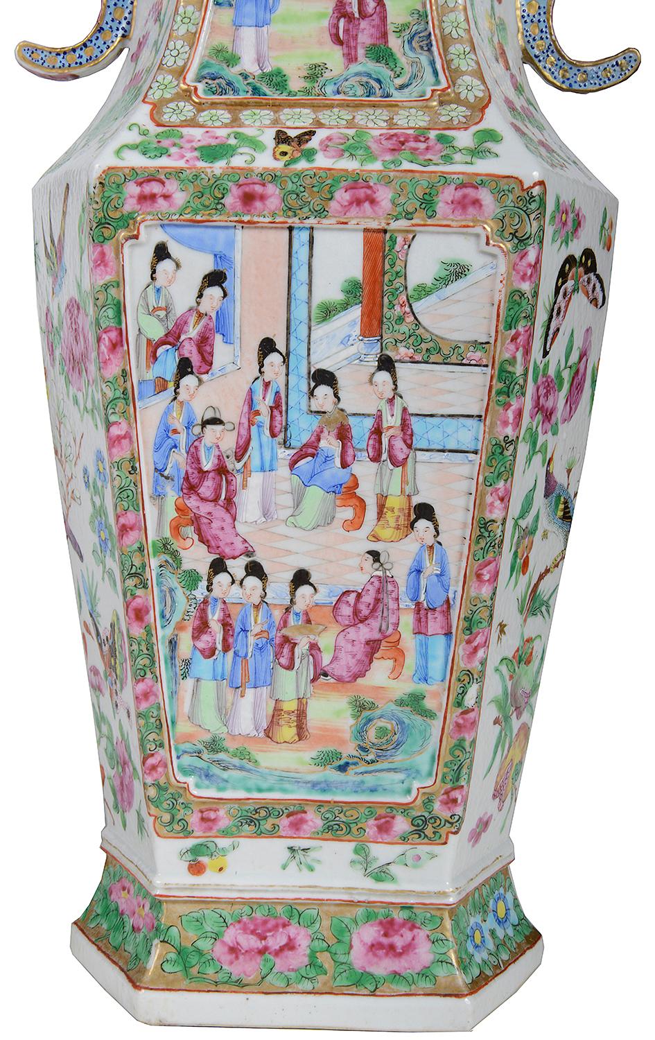 A very good quality pair of 19th century Chinese Cantonese / rose Medallion vases, each having the classical green ground with pink floral decoration, pierced blue handles to either side, inset hand painted panels depicting interior scenes with