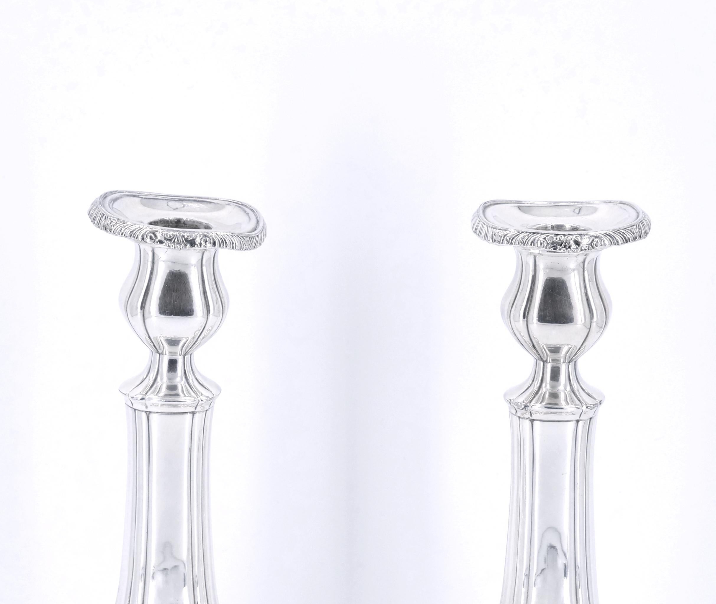 Pair of silverplate candlesticks by Gorham with hand engraved designs in the English Regency style. Each in very good condition with slight bends to one bobeche. Each currently well polished and ready to display. Underside signed with the Gorham