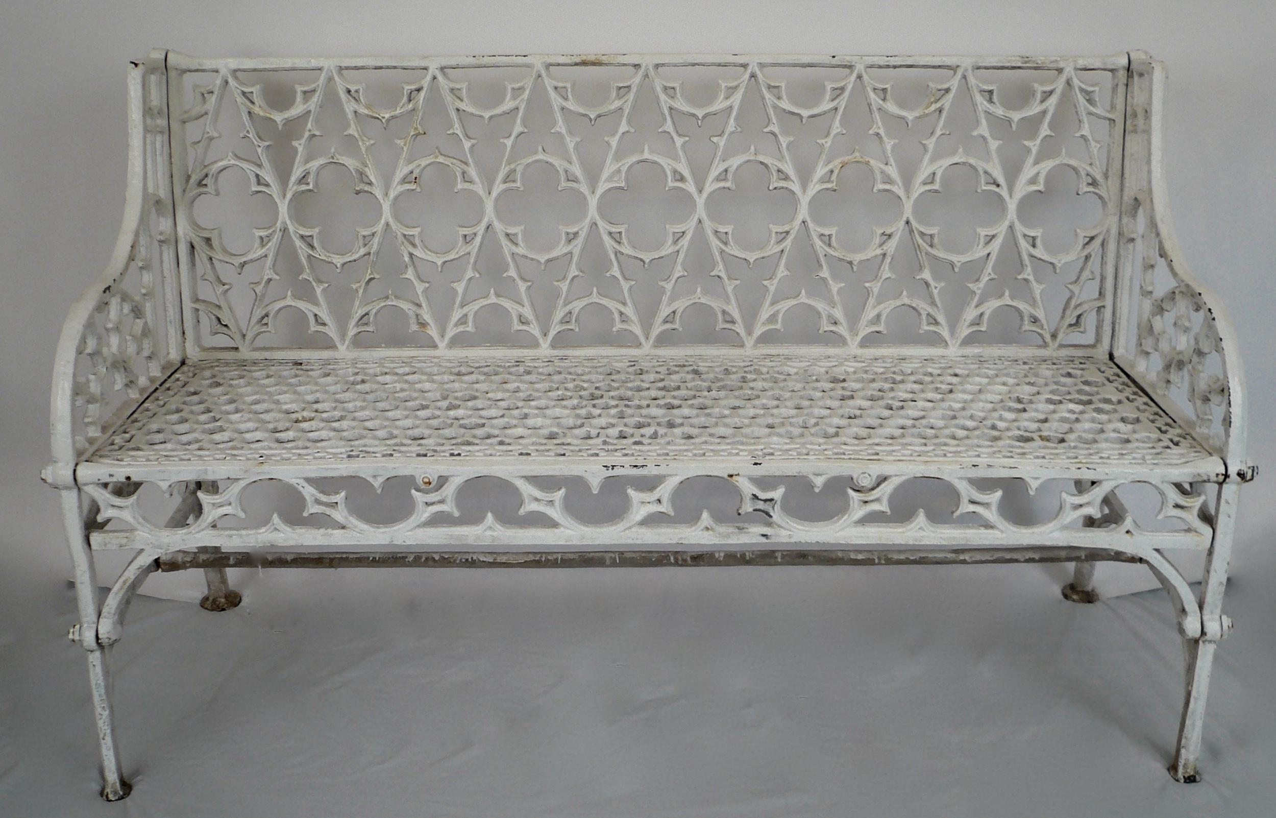 This elegant pair of 'Gothick' style garden seats are heavily cast, and feature an open quatrefoil pattern back.