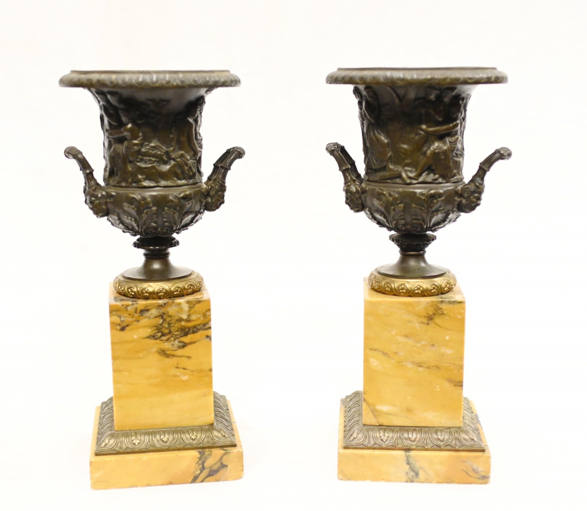 Glorious pair of Grand Tour gilt and bronze urns on marble pedestal stands
Circa 1820 on these Italian antiques
The urns - of campana form - stand on the Sienna marble pedestal bases inset with gilt
Love the salmon pink colour to the marble
The urns