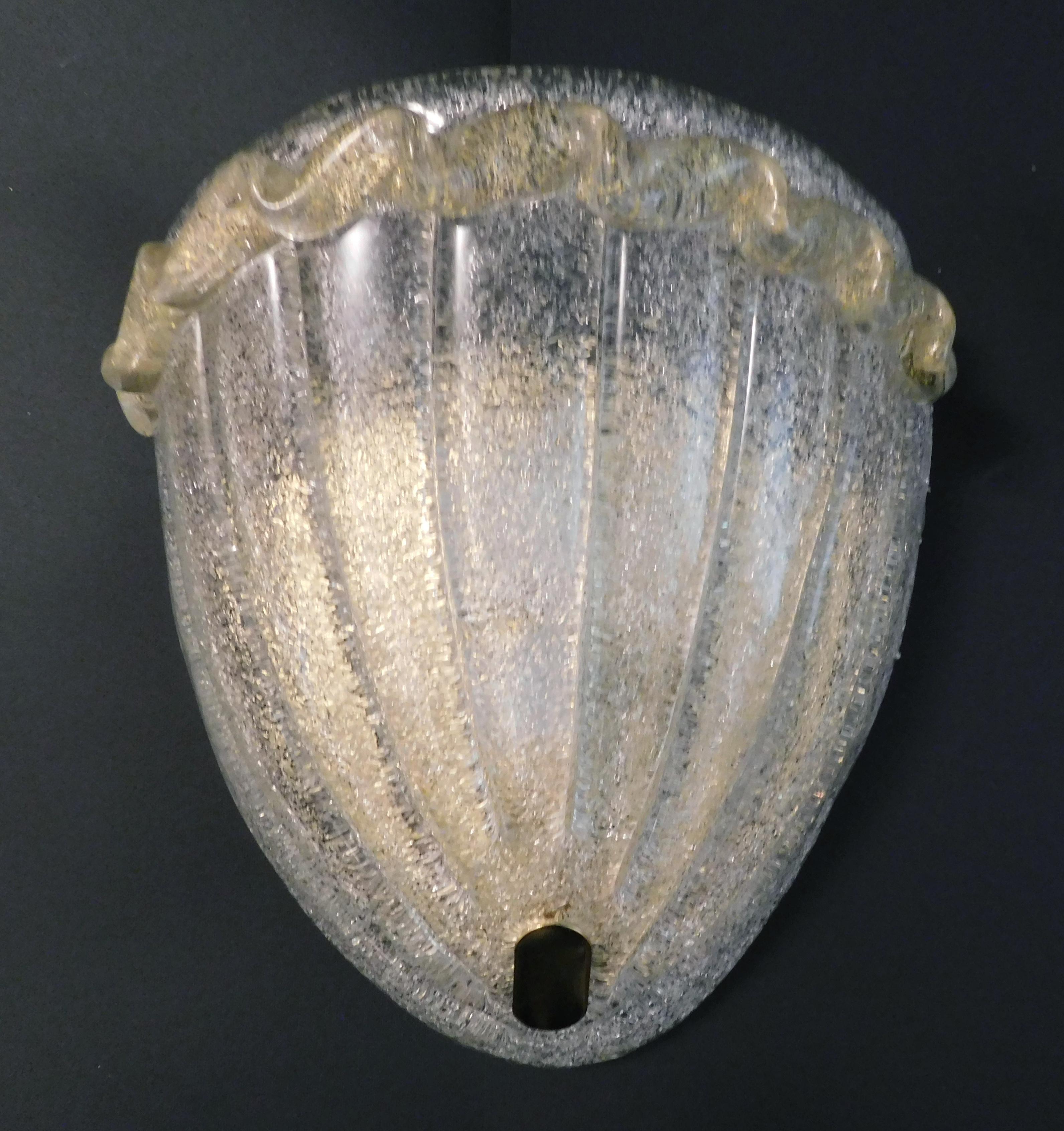 Italienische Wandleuchte mit einem Schild aus Murano-Glas, mundgeblasen in Graniglia-Technik, um einen körnigen, strukturierten Effekt zu erzeugen, montiert auf einem goldfarbenen Rahmen / Made in Italy by Vistosi
Original Herstelleraufkleber auf
