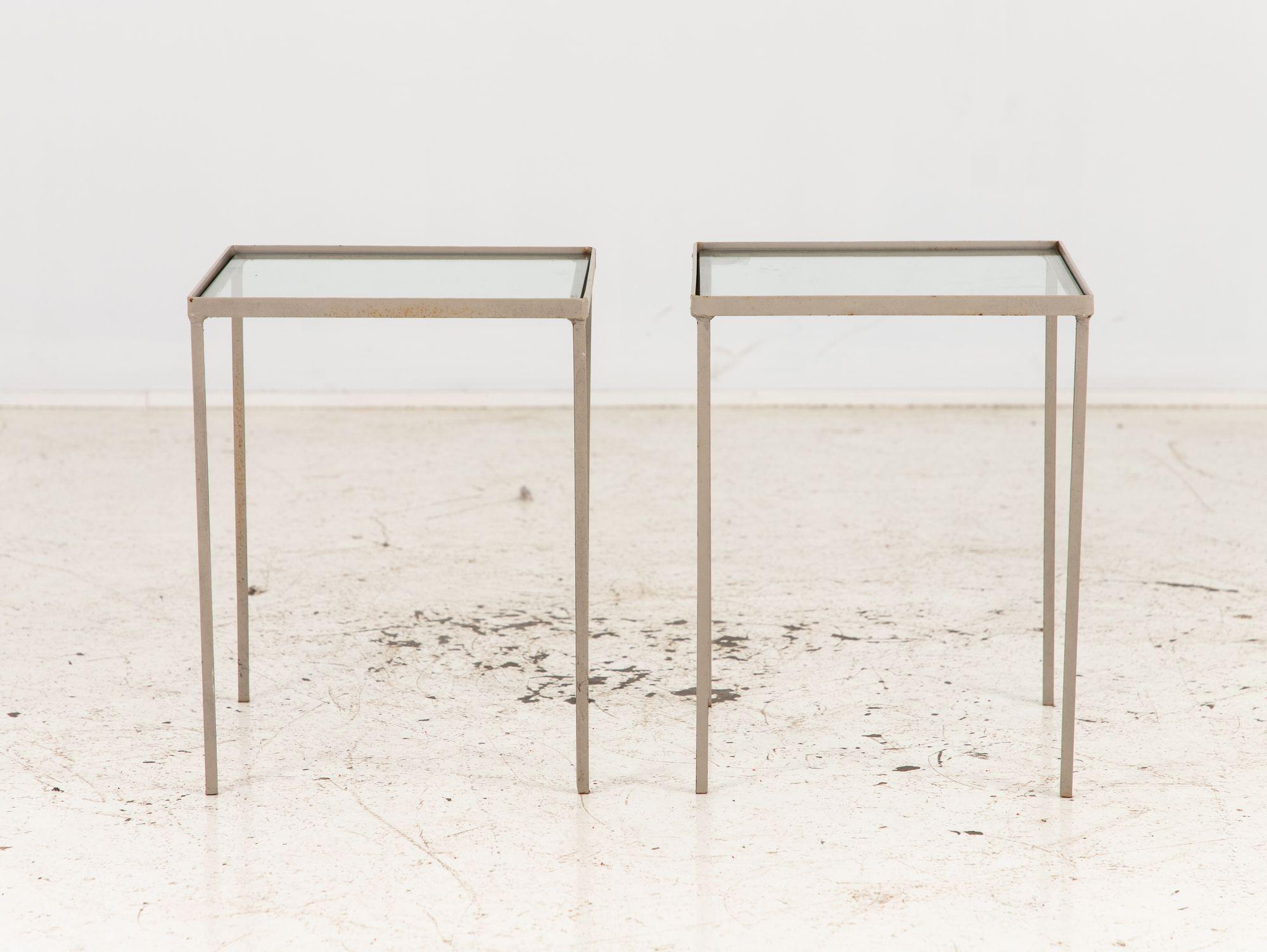 A pair of minimalist square garden side tables, elegantly designed with a modern touch, featuring a sophisticated gray painted finish that effortlessly complements any outdoor setting. Crafted from lightweight yet durable aluminum frames, they