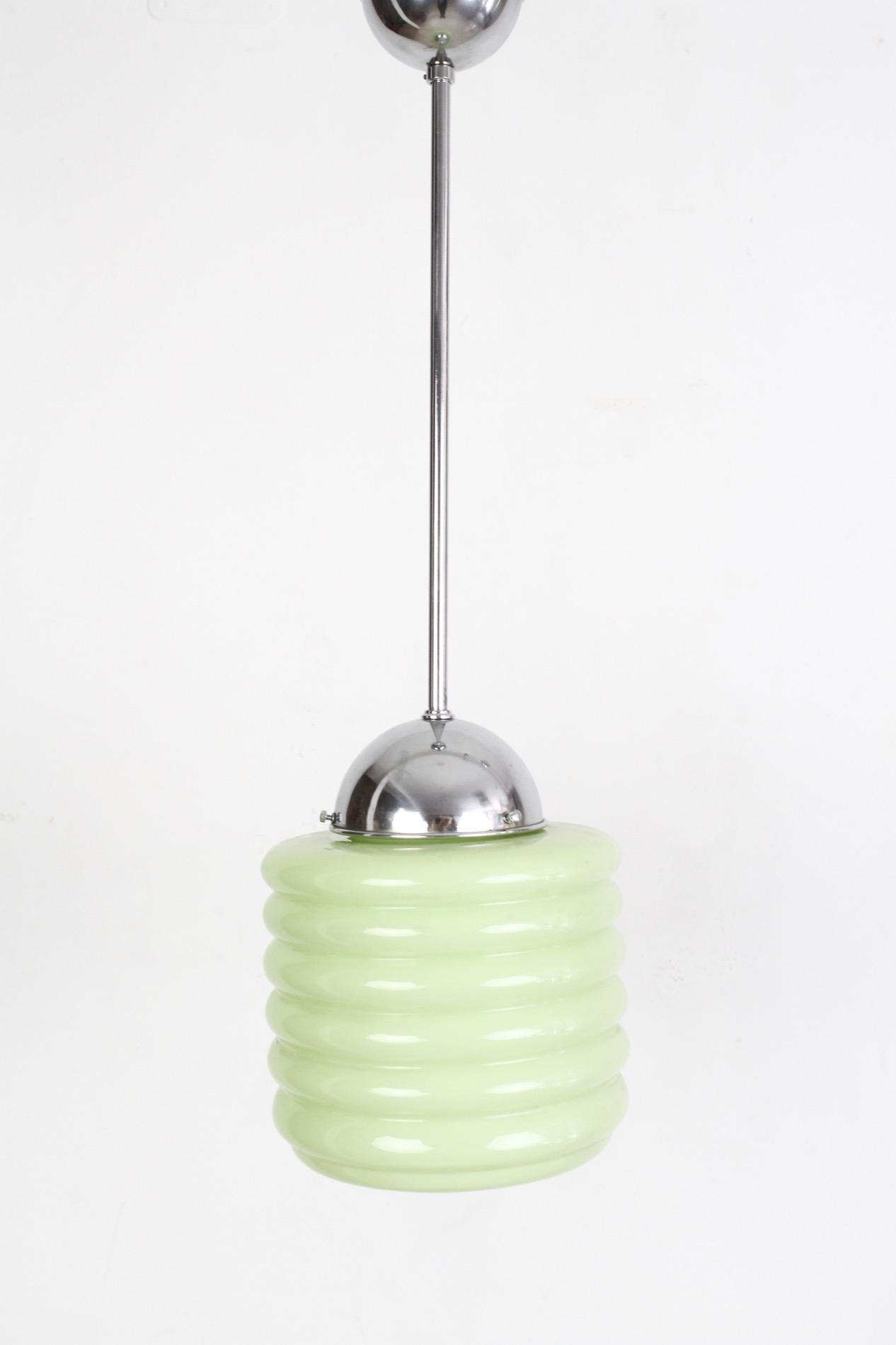 A very special Art Deco glass pendant, look like delicious candy hanging from the ceiling. It was produced in the 1930s, but it is in amazing condition after we restored all chrome-plated parts, fitted with one E27 bulb. 

We used to have two