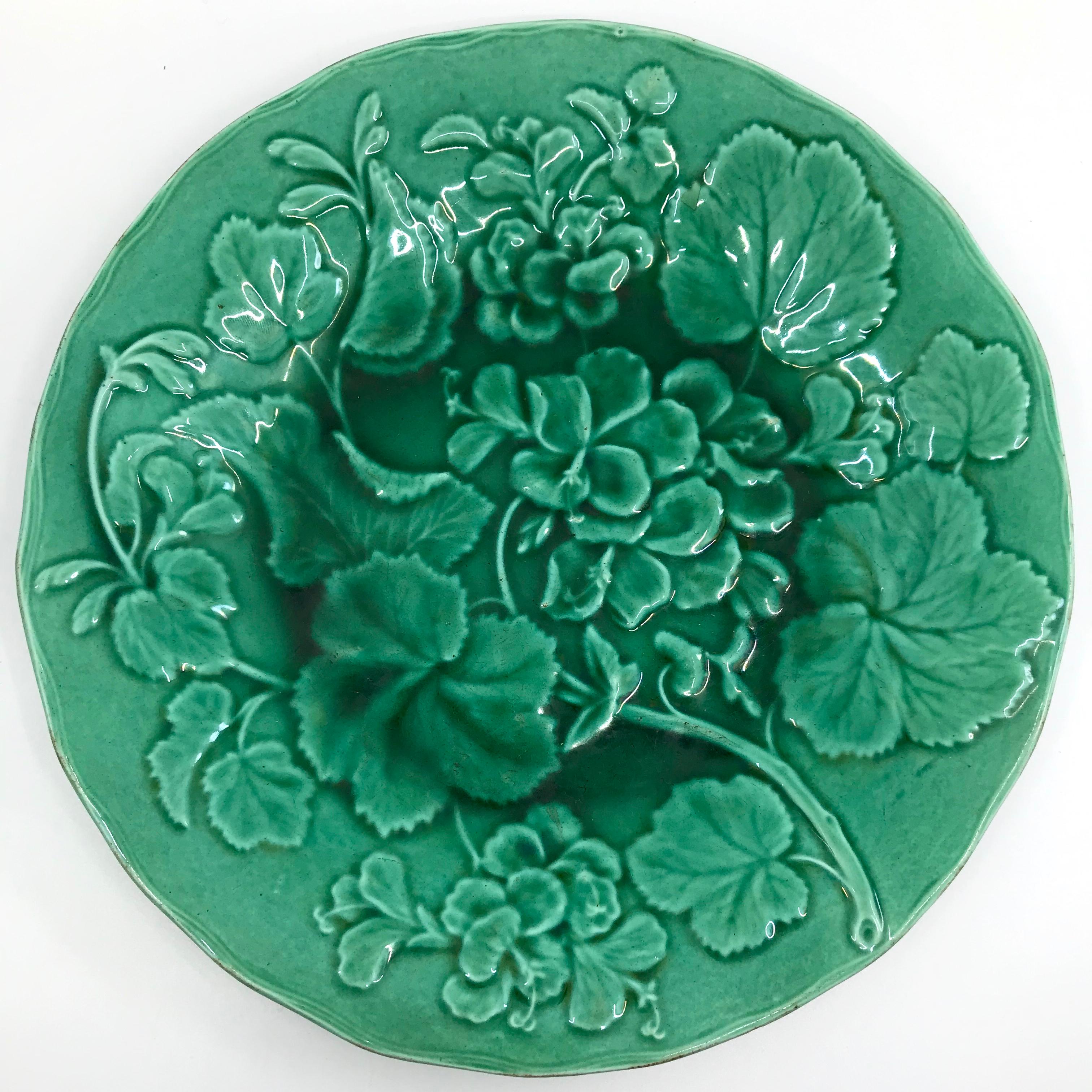 Pair of green majolica geranium plates. Pair of English softly scalloped-edge majolica plates in deep green glaze with geranium flower and leaf motif; one with hairline crack at edge England, late 1800's.
Dimensions: 9” diameter x 1.07” height.