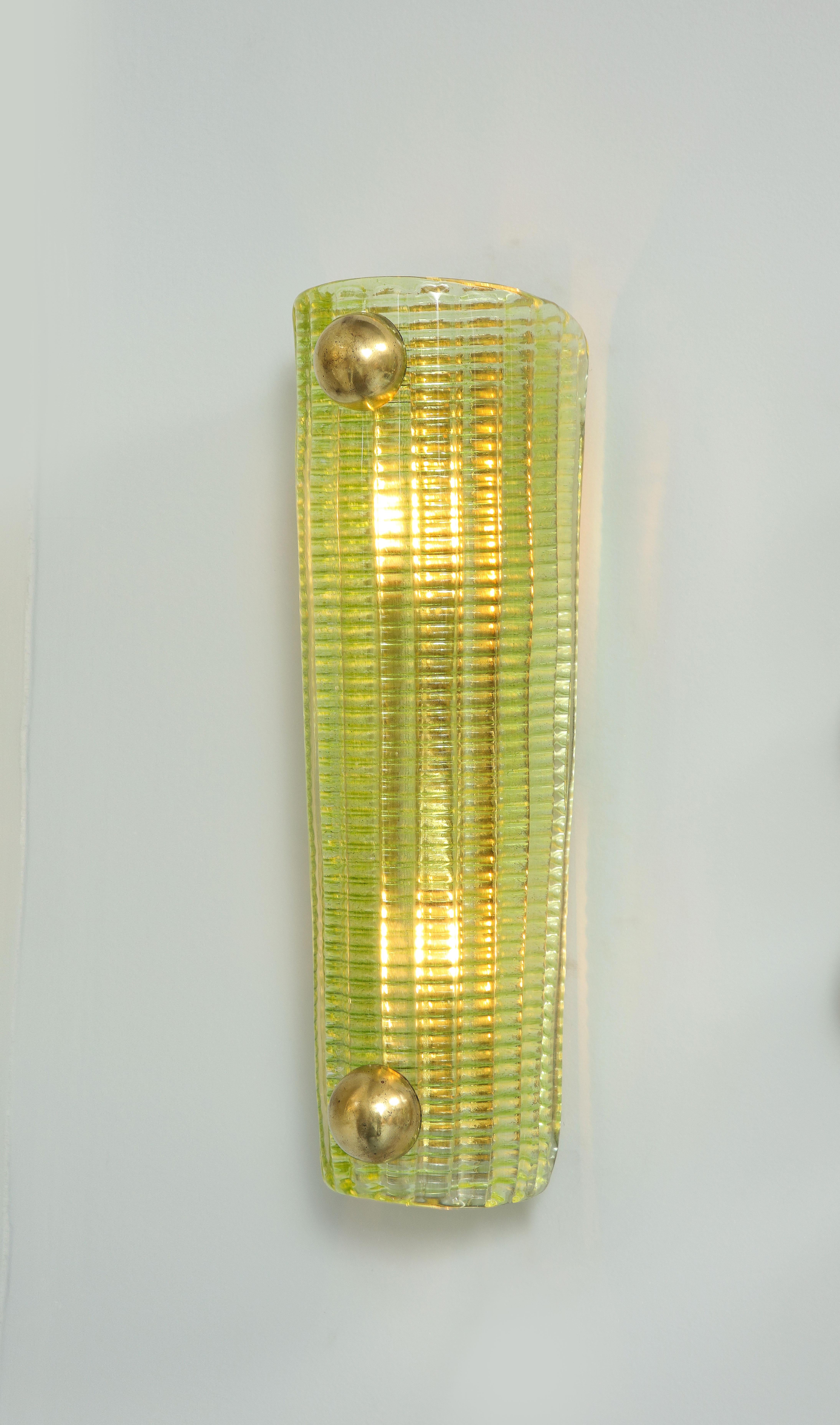 This pair of sconces has an exceptional green. each sconce nests 2 lights, is American wired and has a brass back plate. 