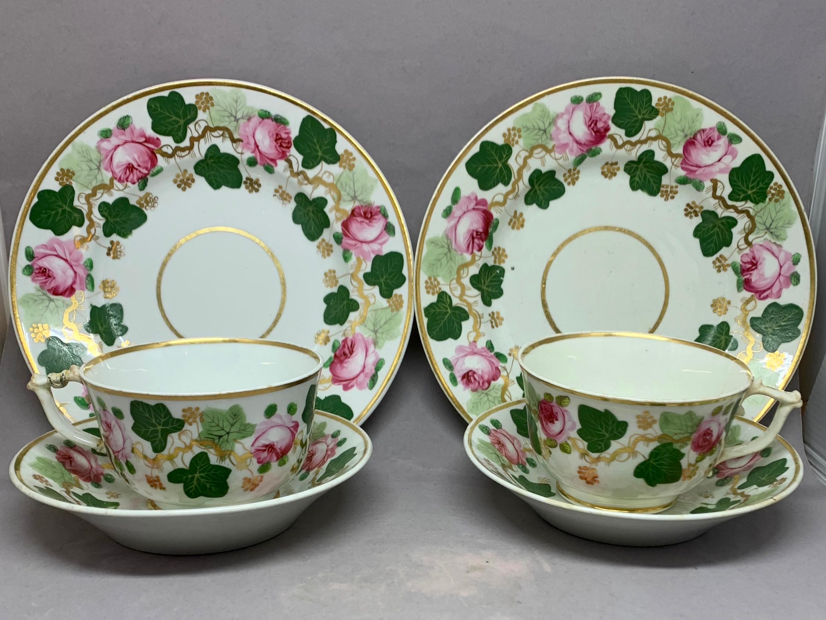 Pair green pink and gilt grape leaf and rose cups and saucers. Pair antique Derby porcelain breakfast or tea sets in vibrant green and soft pink with gilt vine details and rims. Two cups and saucers and two biscuit plates of early manufacture with