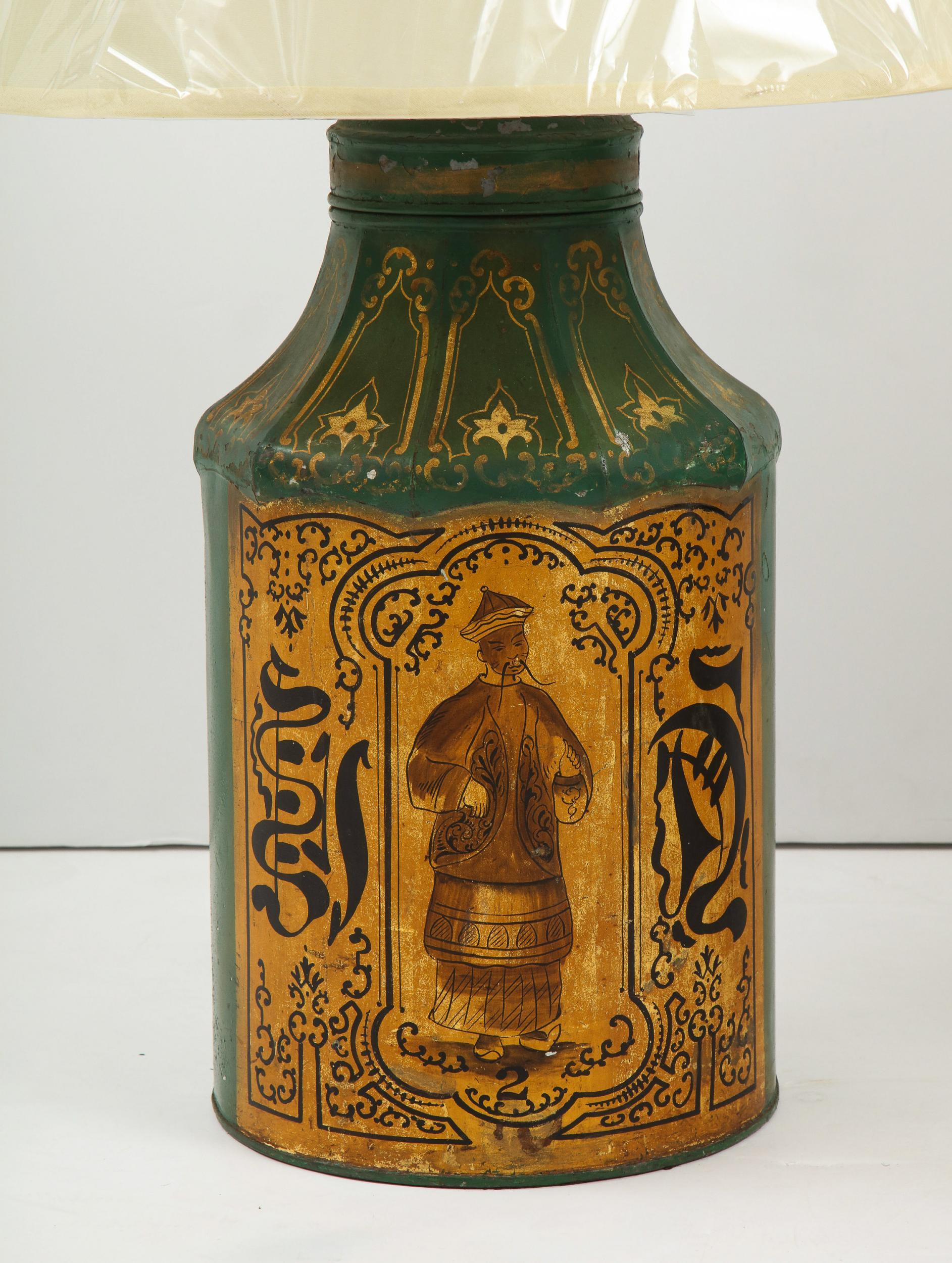 Fine pair of late Georgian chinoiserie decorated tea tins of pagoda form, the green background with Chinese characters and caricatures in gold and black decoration, now mounted as lamps.