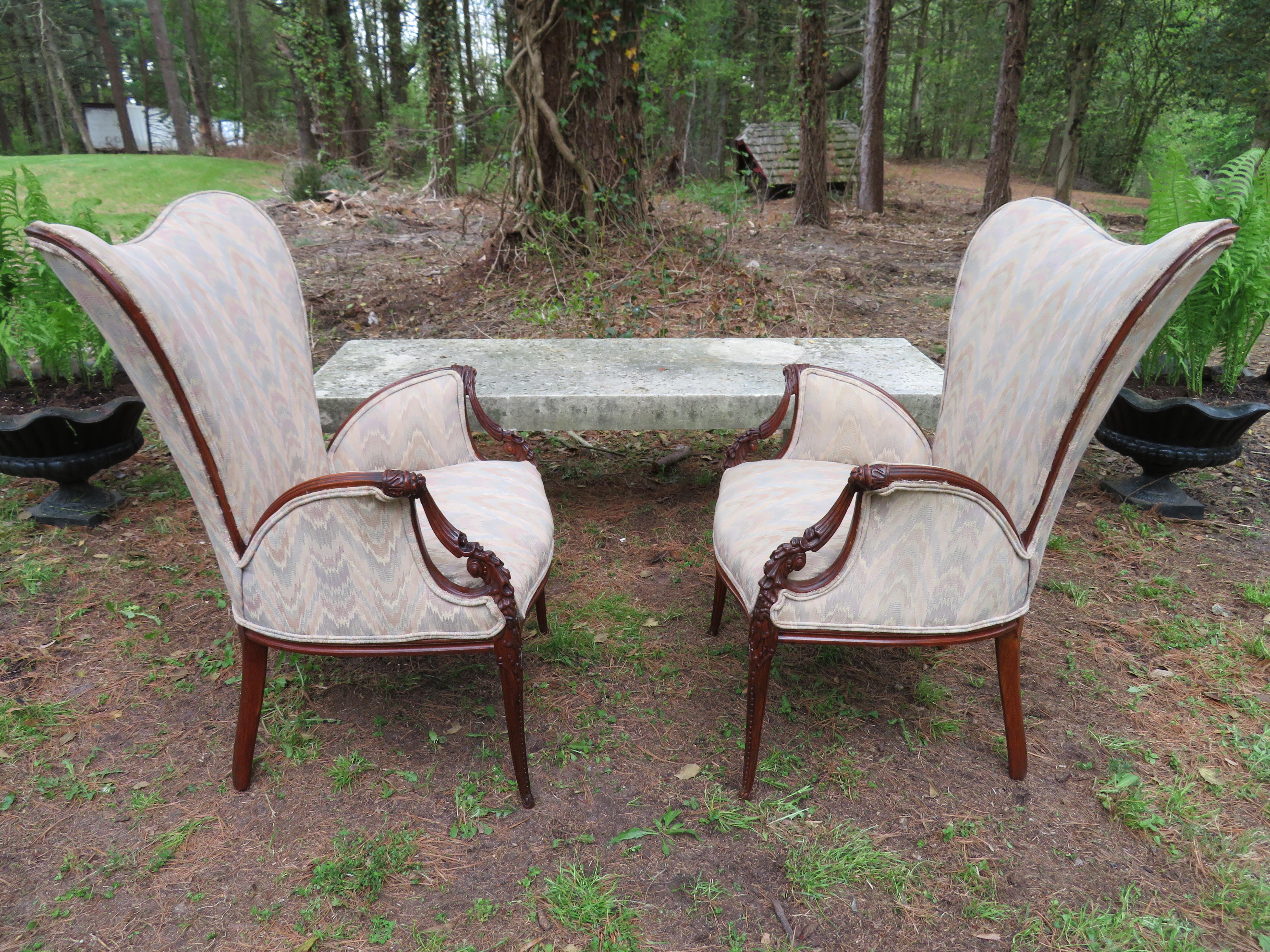 Lovely pair of Grosfeld House attributed to well carved mahogany armchairs. We love the wonderful heart shaped back with the swooping flared ornate arms-very stylish. This pair will need to be re-upholstered, the fabric is dated and worn but that's