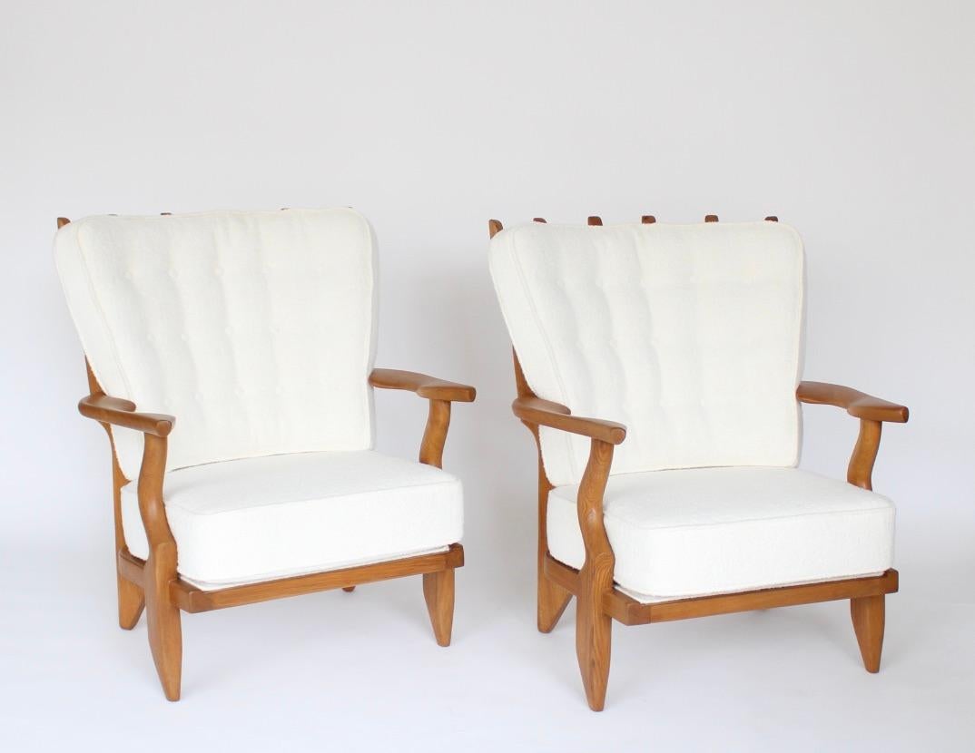 Gullerme et Chambron or Guillerme and Chambron pair of extraordinary French vintage circa 1950 Petite Repos high back lounge chairs in solid oak with the typical characteristic finger motif at the backs for Votre Maison. 
This highly sculptural