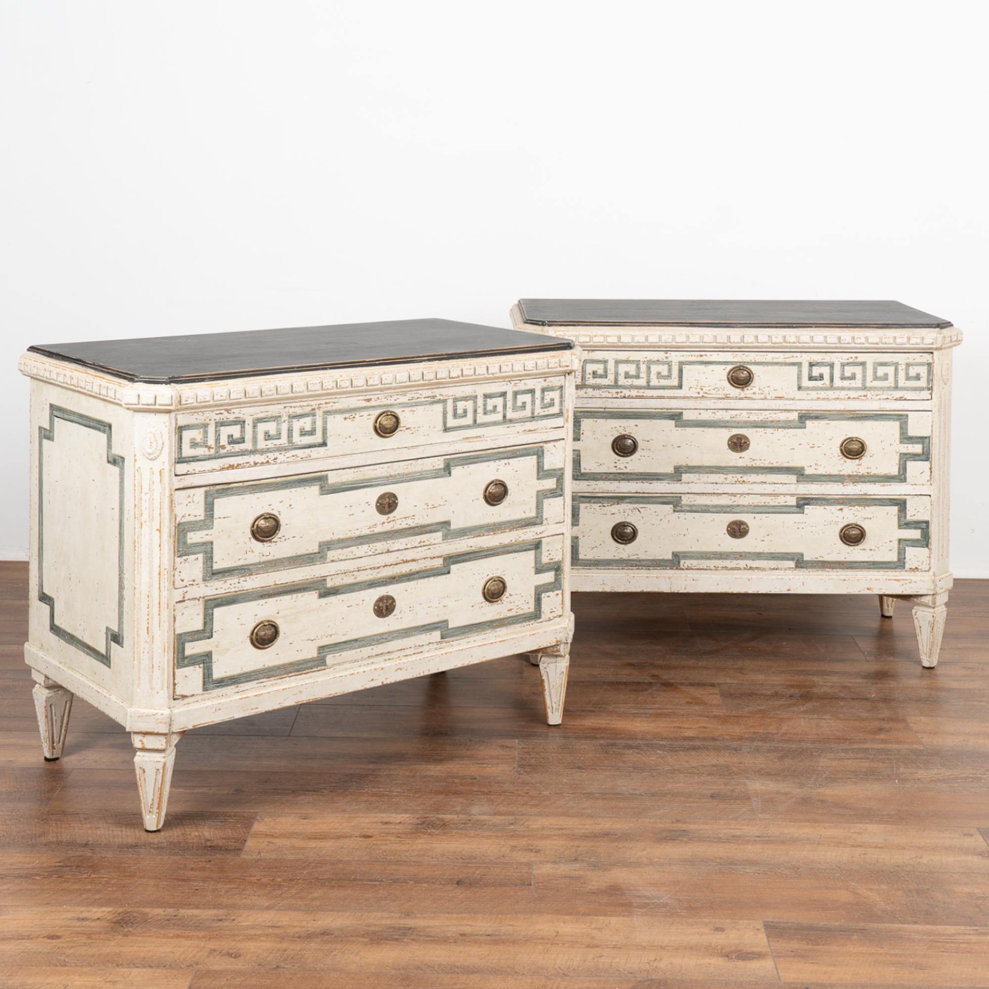 A pair of decorative pine Gustavian chest of drawers with traditional carved dentil moldings, canted fluted side posts with upper carved medallion, raised on four tapered fluted feet.
Three drawers, upper decorated with contrasting striated