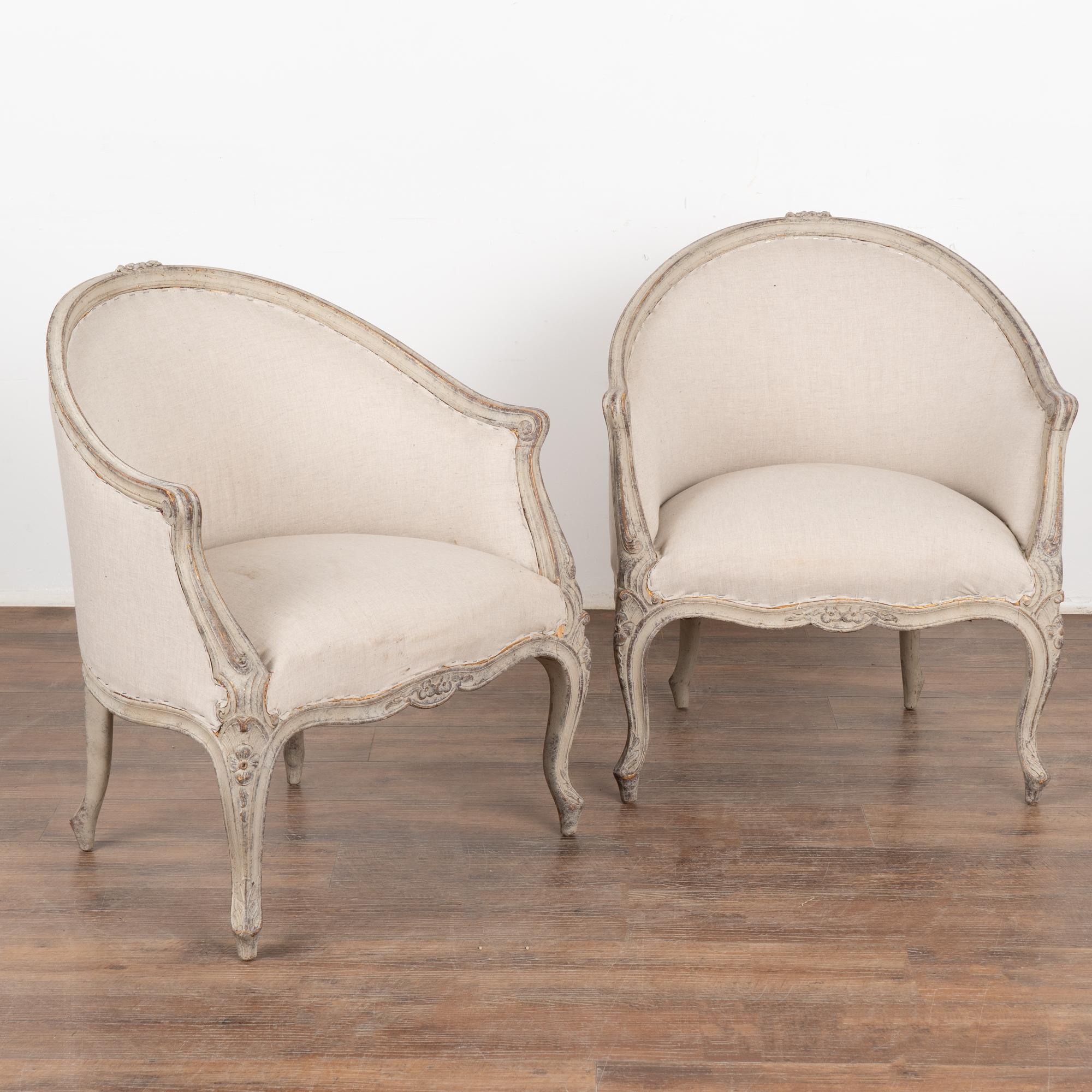 This pair of Swedish arm chairs have a gently curved barrel back and cabriolet legs adding to the graceful Gustavian appeal of each.
Delicate carving and curves are seen throughout the frame.
The newer professionally applied antique white/soft gray