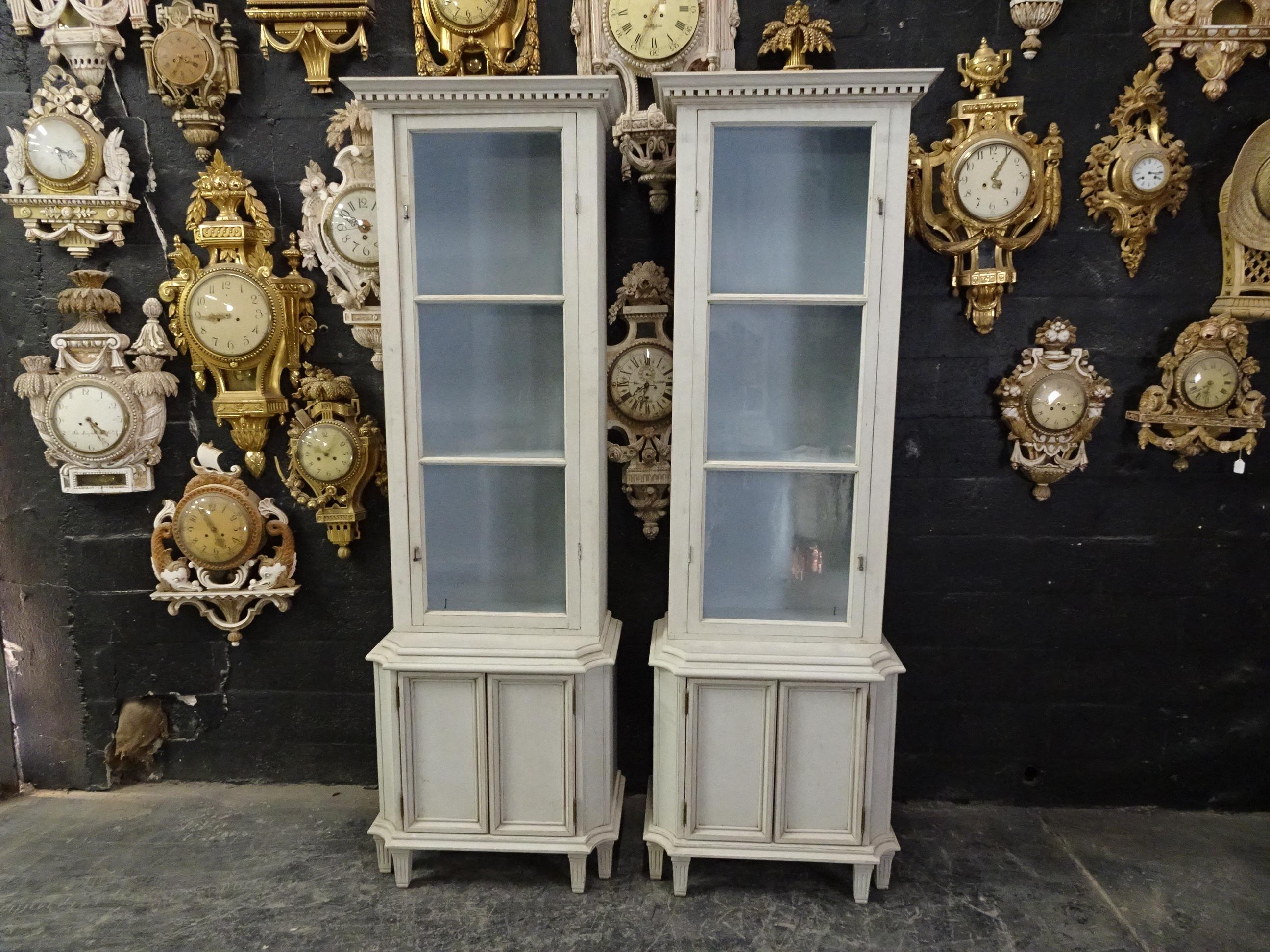 This is a pair of Gustavian style glass top display cabinets, They have been restored and repainted with milk paints 