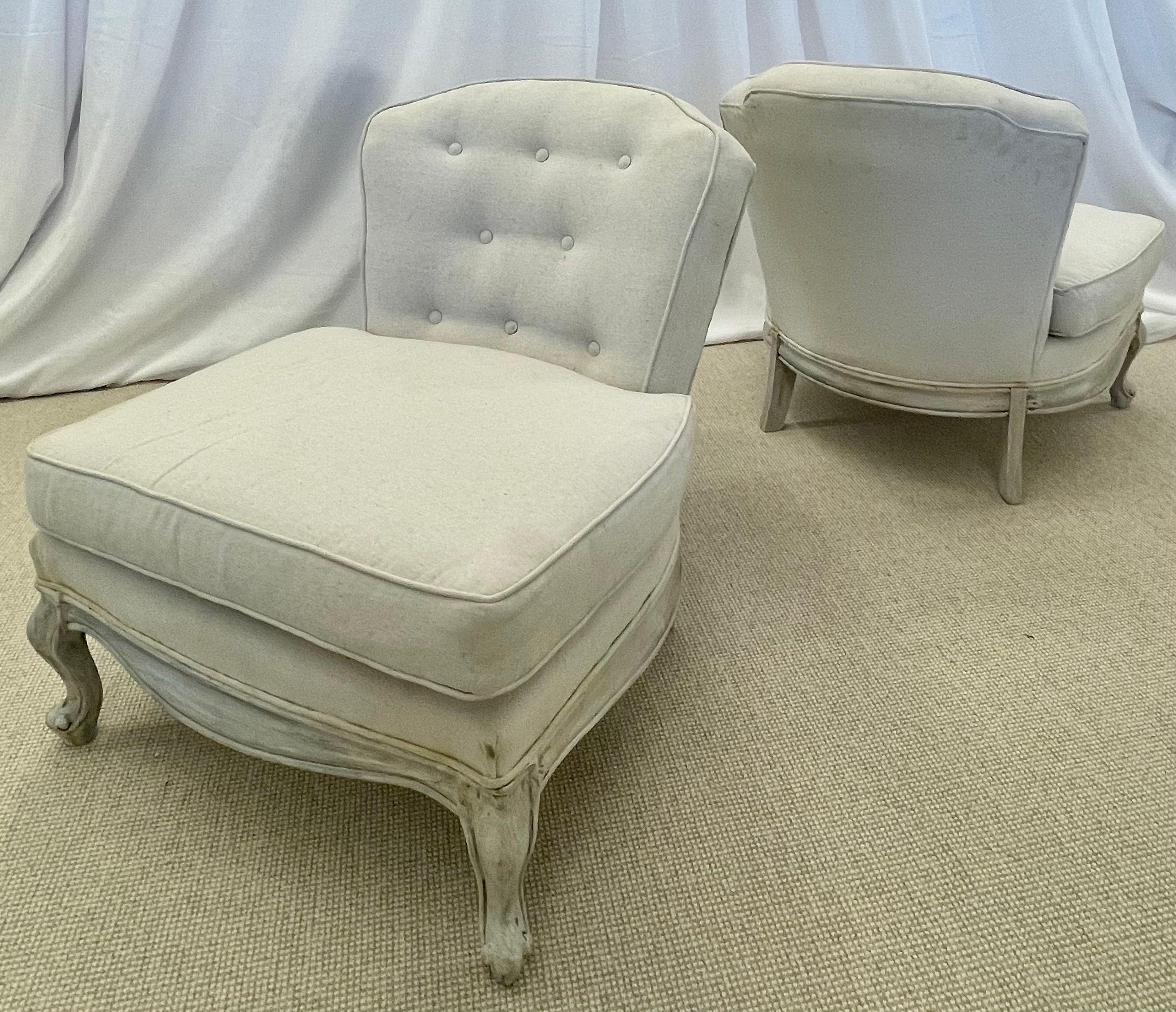Pair of Gustavian slipper chairs, Swedish style distressed paint decorated, Linen.
Chic low profile slipper chairs having a hand painted distressed frame in the Gustavian / Swedish style. Off-white linen upholstery with tufted back.
Measures: seat