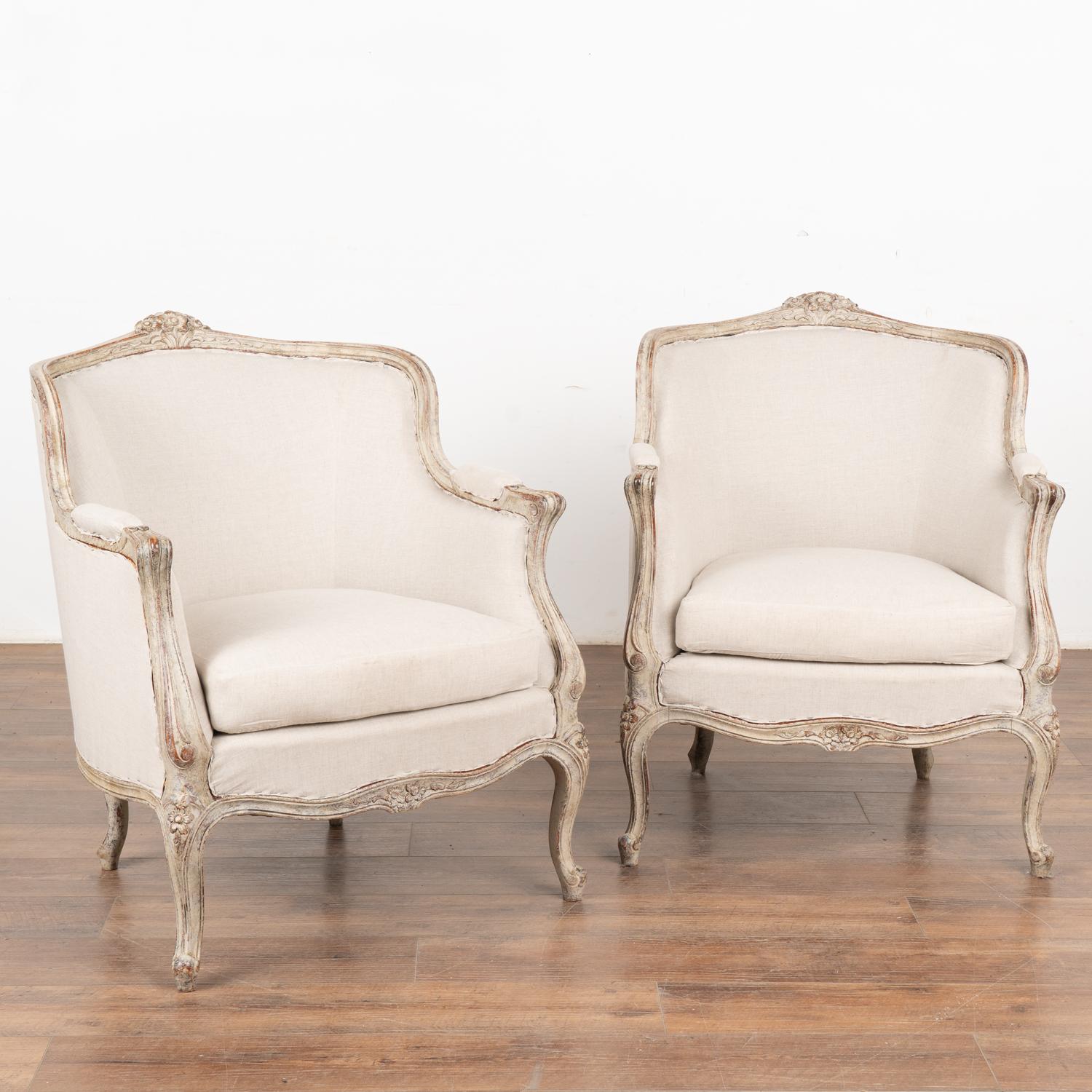 This pair of Swedish arm chairs have a gently curved back, cabriolet legs and decorative carving embellish the skirt and top which all add to the graceful appeal of each.
The newer professionally applied antique white layered painted finish has been