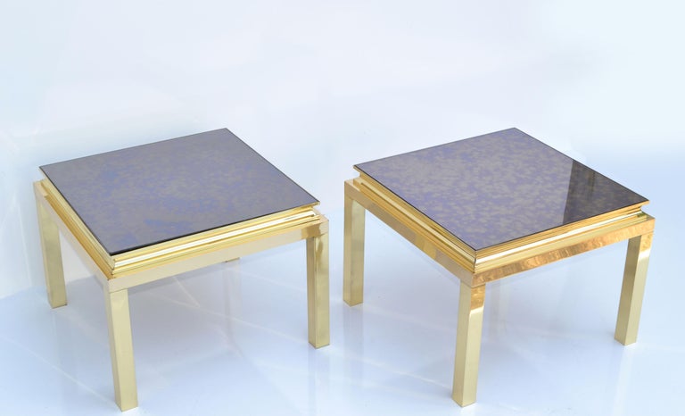 Pair of Guy Lefevre for Maison Jansen French 1960 square Side or End Tables, featuring a polished brass frame and a vintage cloudy mirror Glass Top.
Brass is newly polished and the original Mirror Glass has some scratches due to History. 1 Mirror