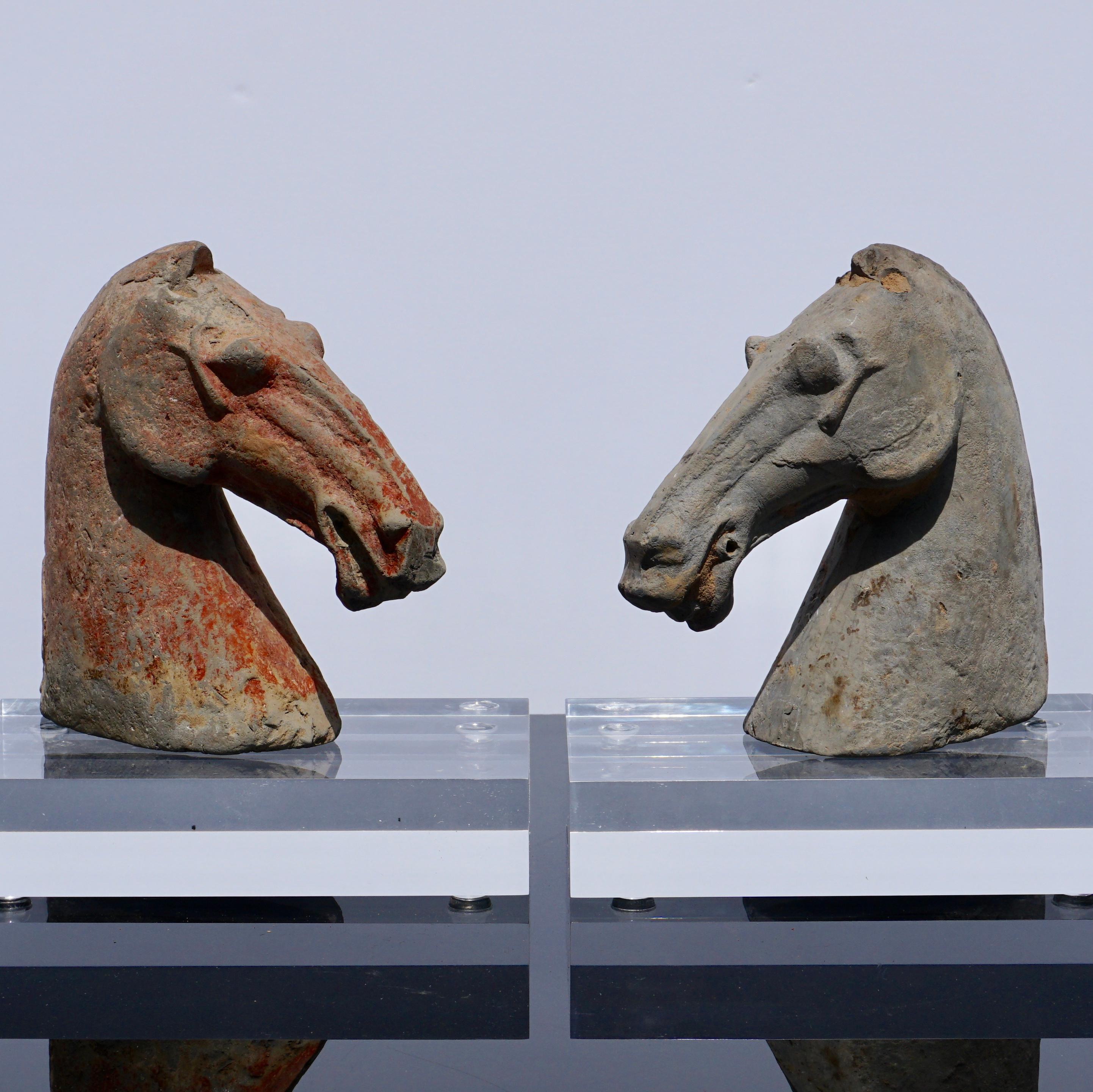 Pair of Chinese Han dynasty horse heads
Han dynasty (206 BC-220 AD) earthenware gray pottery
Each approx.: 6.25 inches high. 6.5 inches wide. 2.5 inches depth
Accompanied by museum quality black base and clear plexiglass display stands. Not