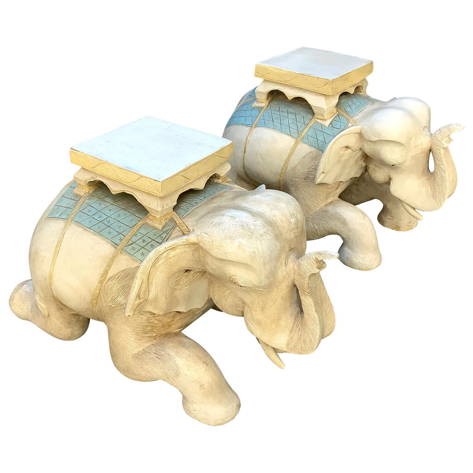 A wonderful vintage pair of solid wood hand carved elephant garden seats. Beautiful polychroming in yellow & robins egg blue. Opposing pair. Very nice detail. Heavy, solid.