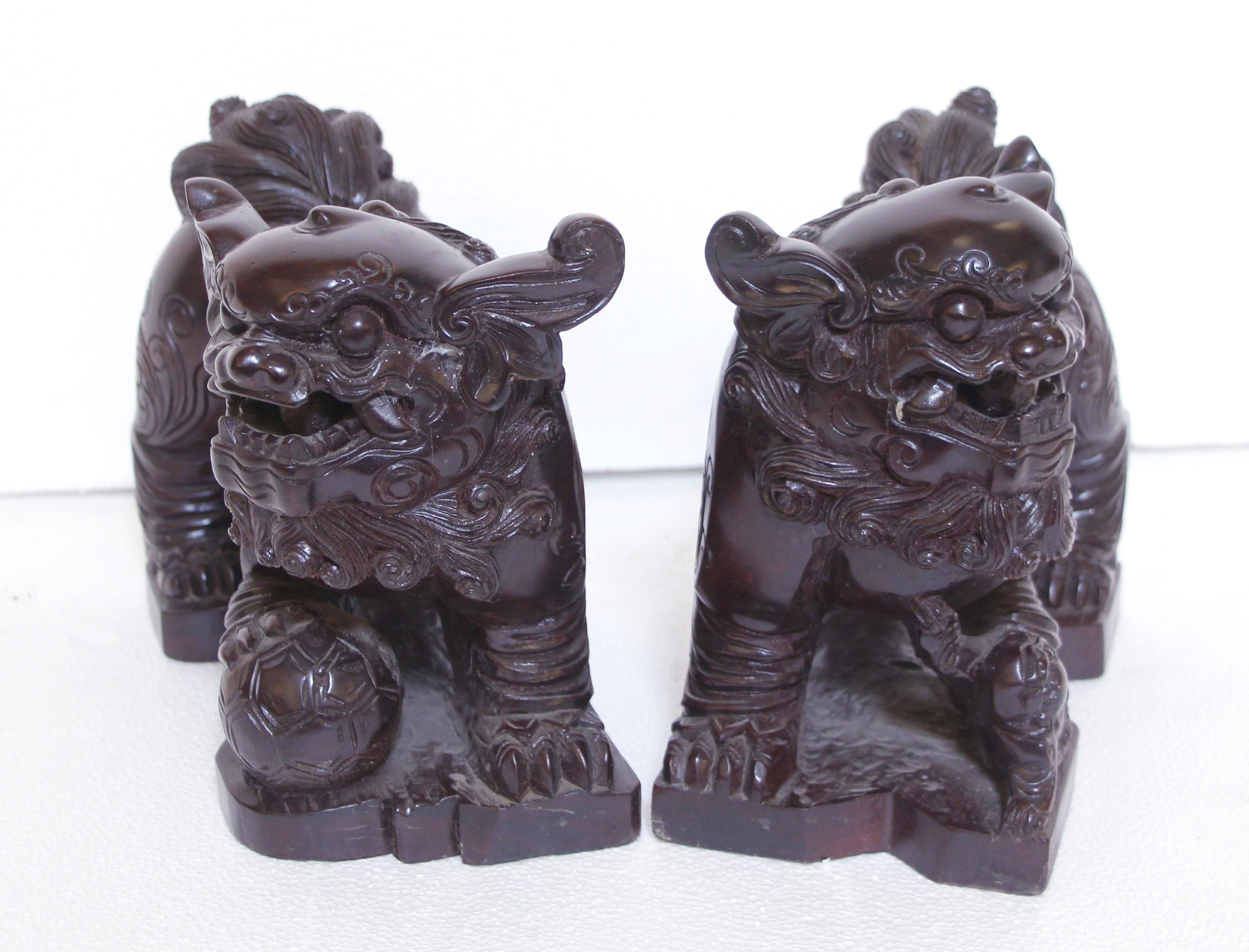 20th Century pair of hand carved Cambodian foo dogs made of a very dark stained wood. Good condition with appropriate wear from age. Priced as a pair. Please note, this item is located in one of our NYC locations.