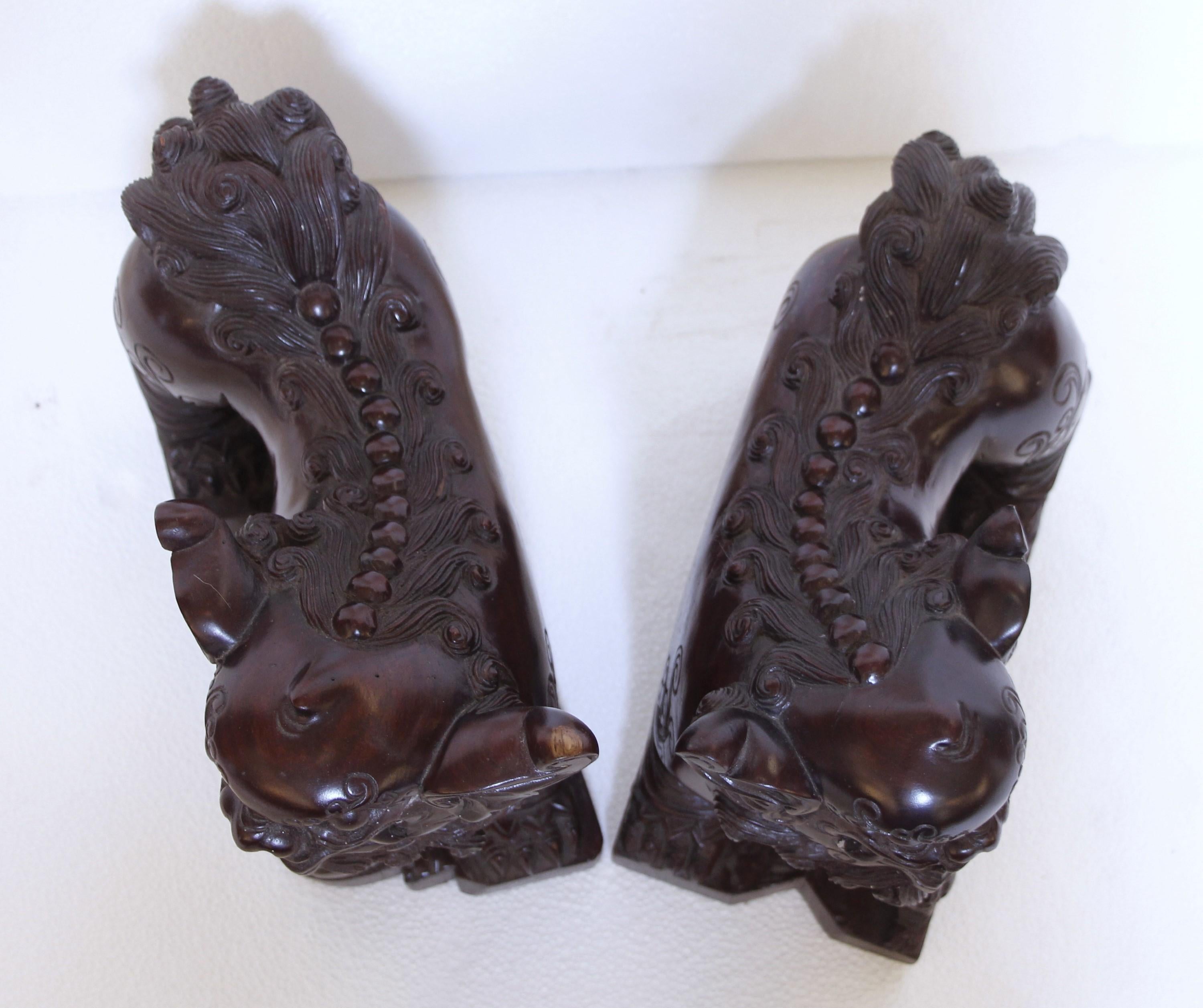 Pair Hand Carved Wood Cambodian Foo Dogs In Good Condition For Sale In New York, NY