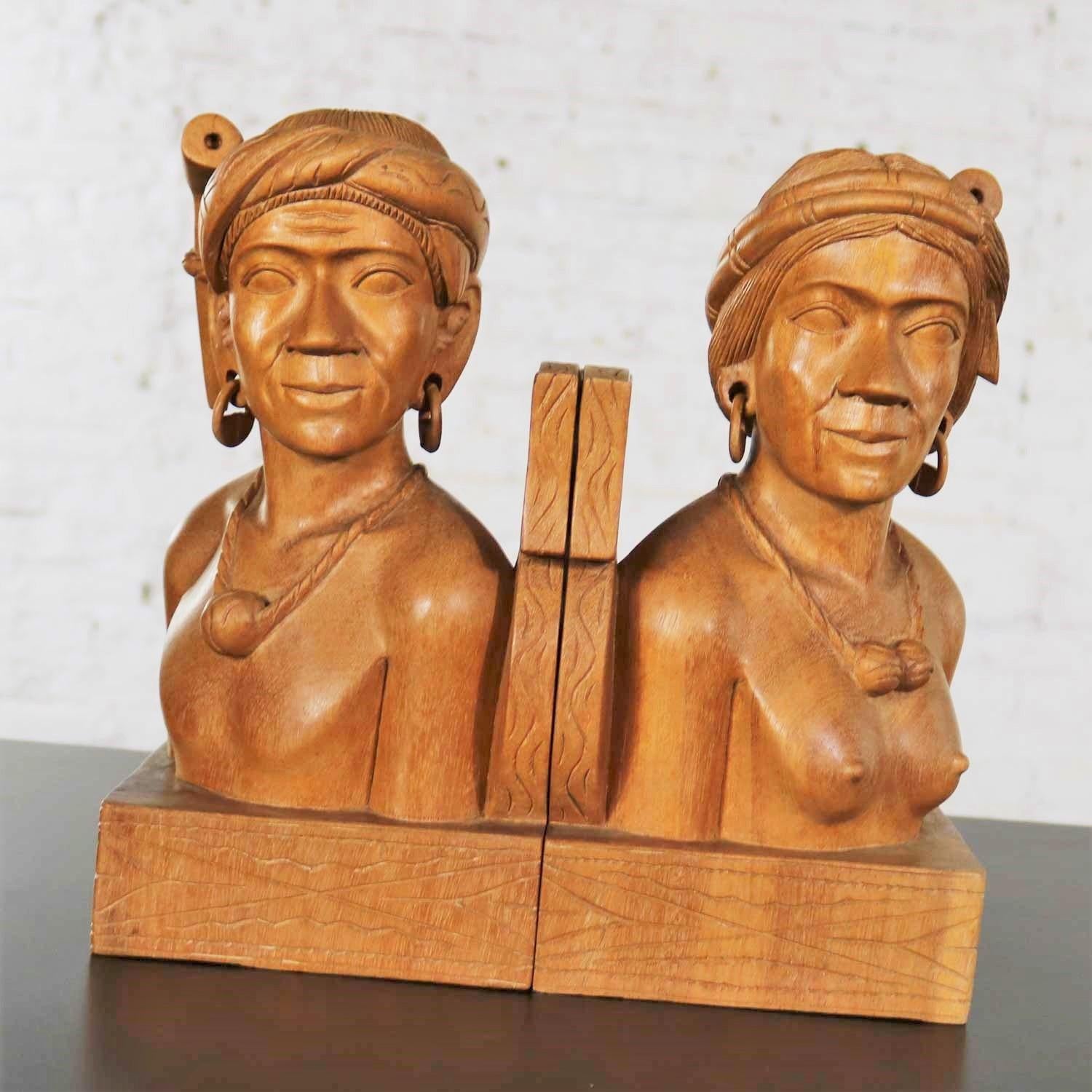 Handsome pair of hand carved wood tribal figural bookends. One male and one female. They are in fabulous vintage condition. Please see photos, circa mid-20th century.

Calling all bibliophiles! Looking for a grand pair of bookends to support your