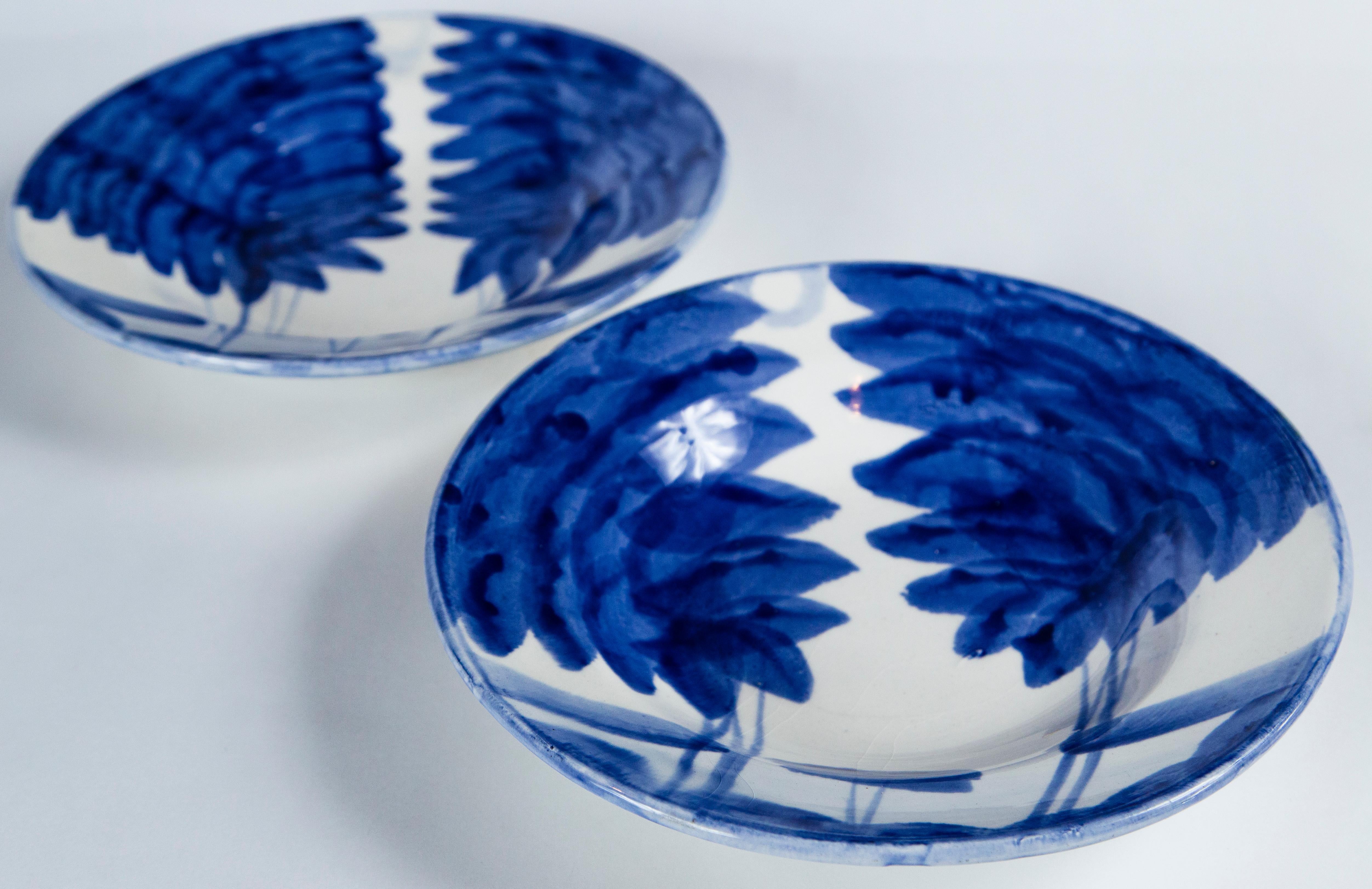 Pair of hand painted blue and white bowls, Europe, mid-20th century. Abstract design with a rich blue glaze on white ground.