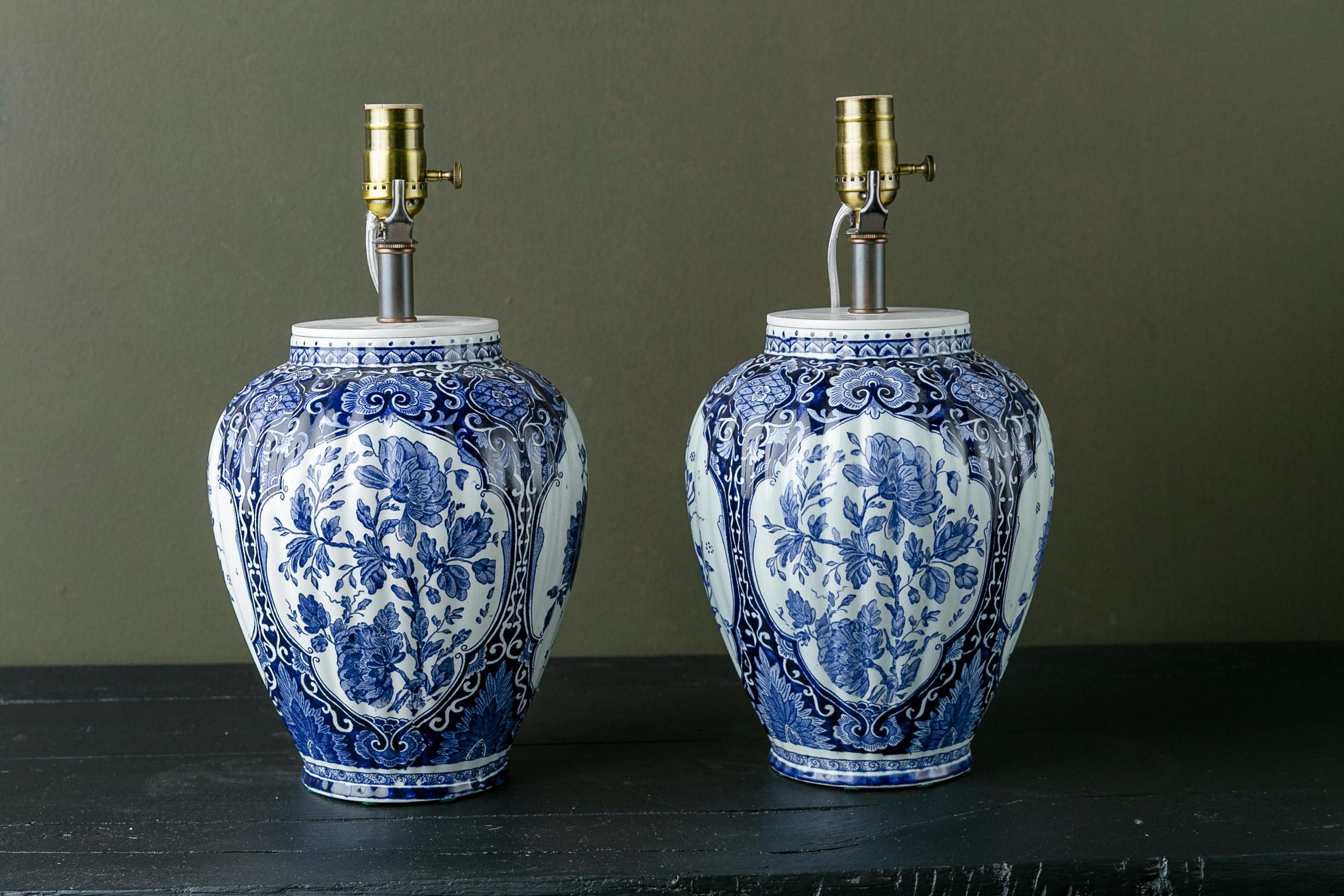 This charming pair of delft table lamps looks as fresh today and when they were made. A beautiful, Classic pair of lamps. The wiring of the lamps has been changed since photography to come from the bottom of the lamps which have been drilled for the