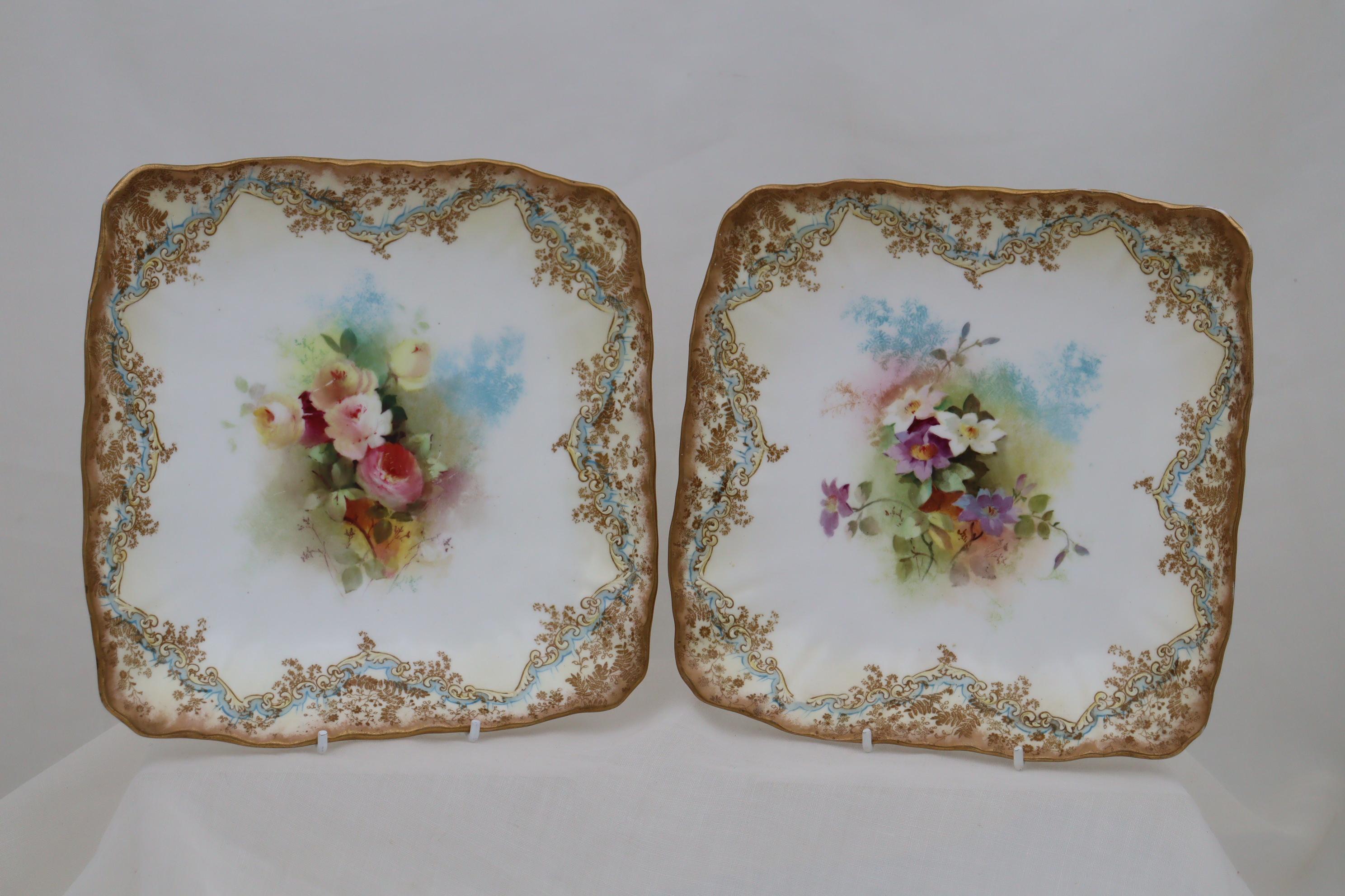 These square, shallow Doulton Burslem porcelain bowls feature sprays of delicately hand painted flowers to the centre, while the border is composed of raised paste arabesques in cream, a painted border of pale blue and an intricate gilt border with