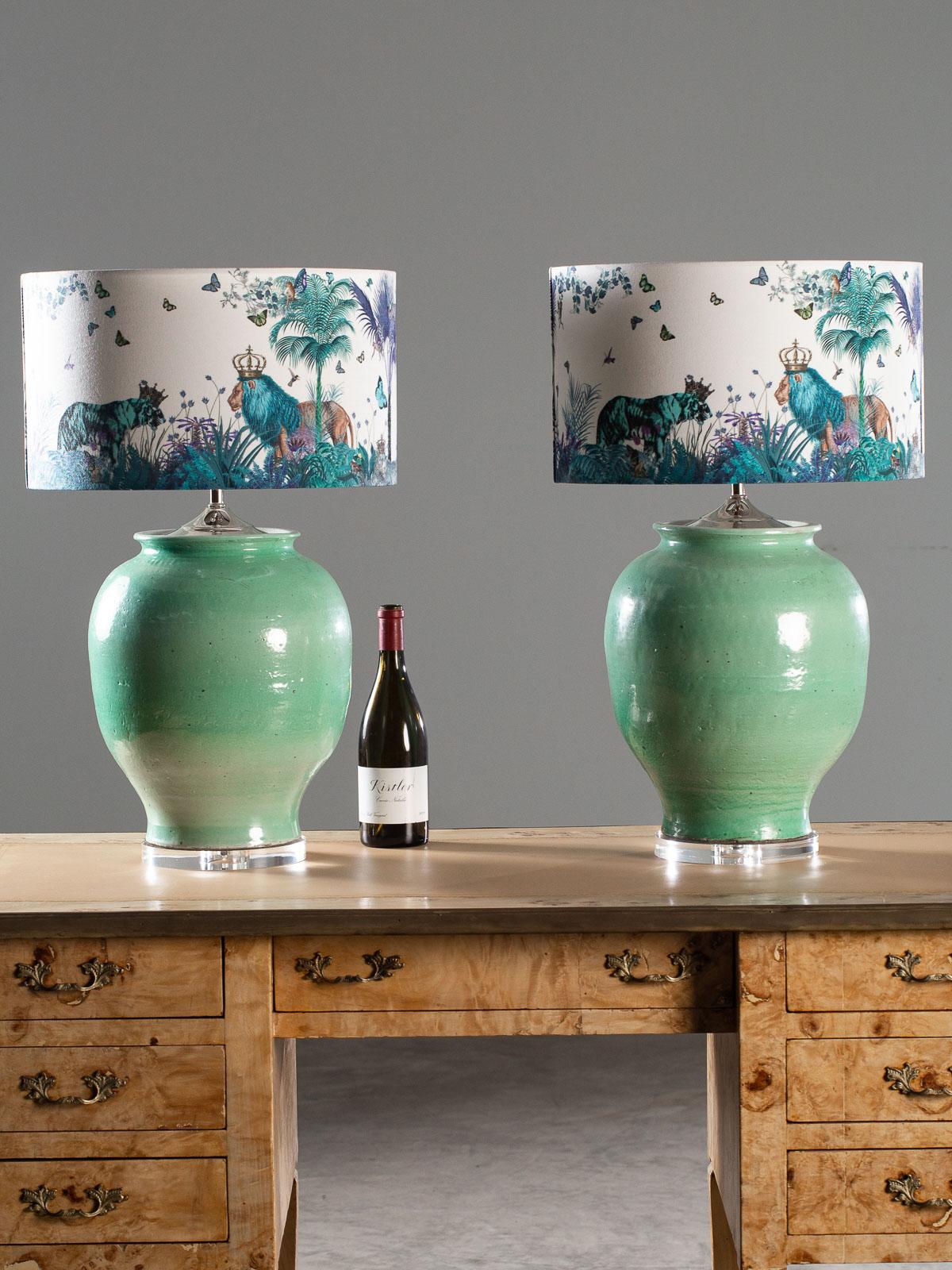 A pair of beautiful handmade turquoise ceramic vases transformed into custom lamps with Lucite bases. The gorgeous urns feature a rippled surface indicative of their hand crafted origin. Please enlarge all the photographs to see the unique details